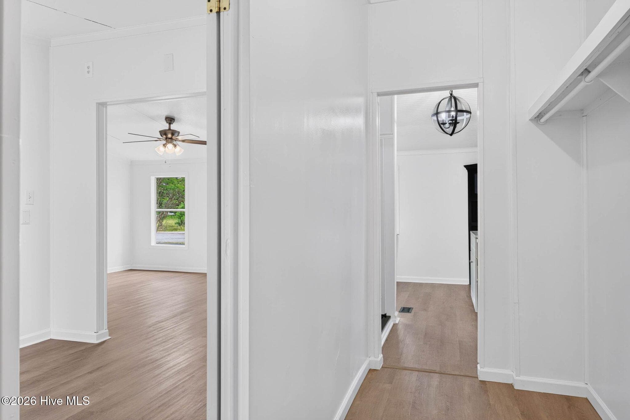 The thoughtfully designed hallway provides easy access to the home's bedrooms while maintaining a bright, open feel throughout the interior. - 1199 Zack Street SE, Bolivia, NC 28422