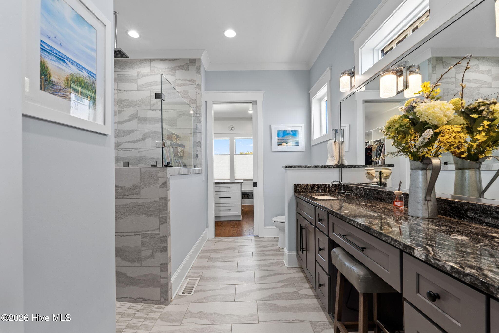 Tiled floors continue into shower with same tile for a tailored, sophisticated look - 2775 Long Bay Drive SE, Southport, NC 28461