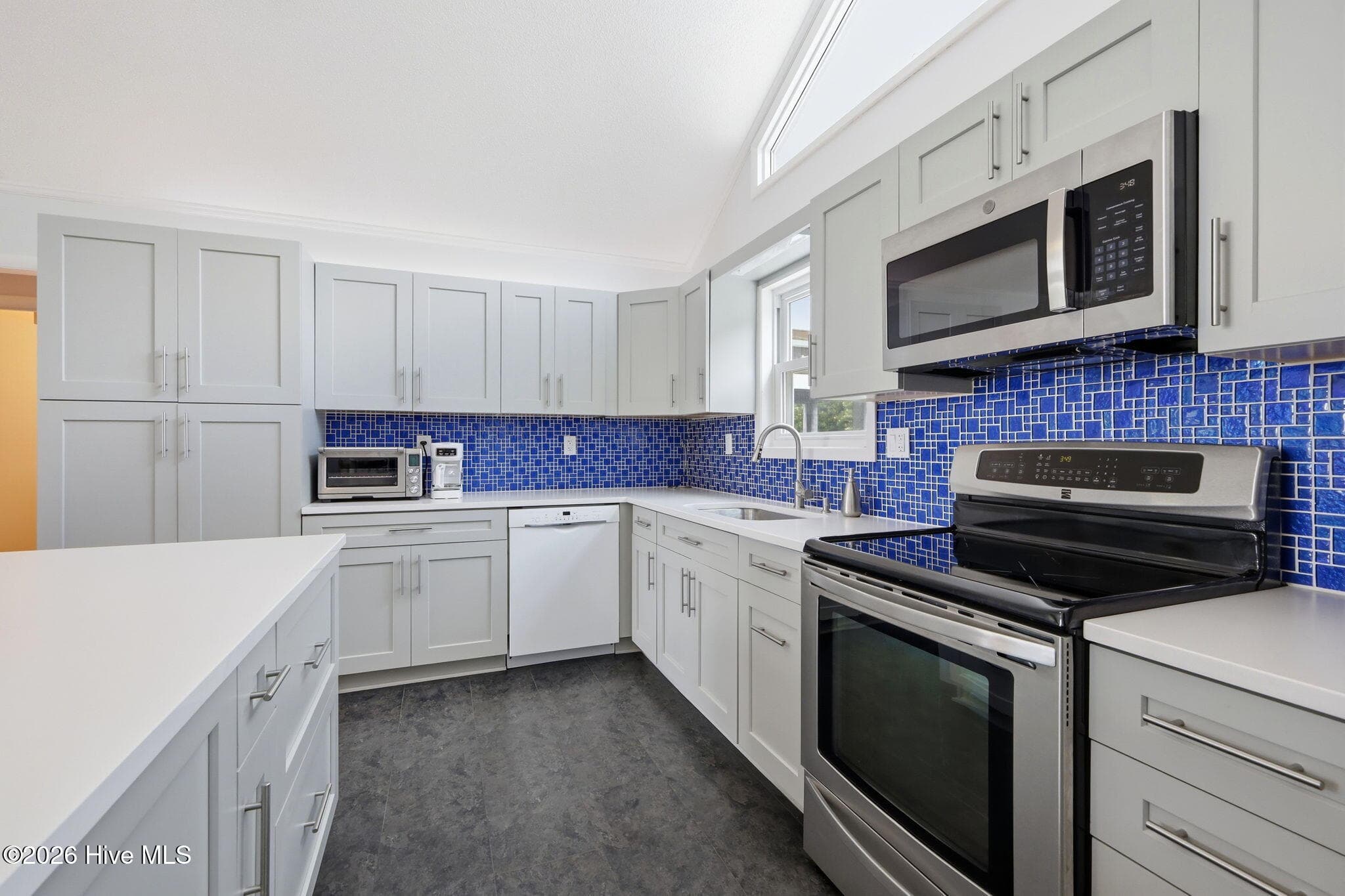 Quartz Topped Kitchen w/Tile Back Splash & Stainless Appliances - 1607 Emerald Drive, Emerald Isle, NC 28594