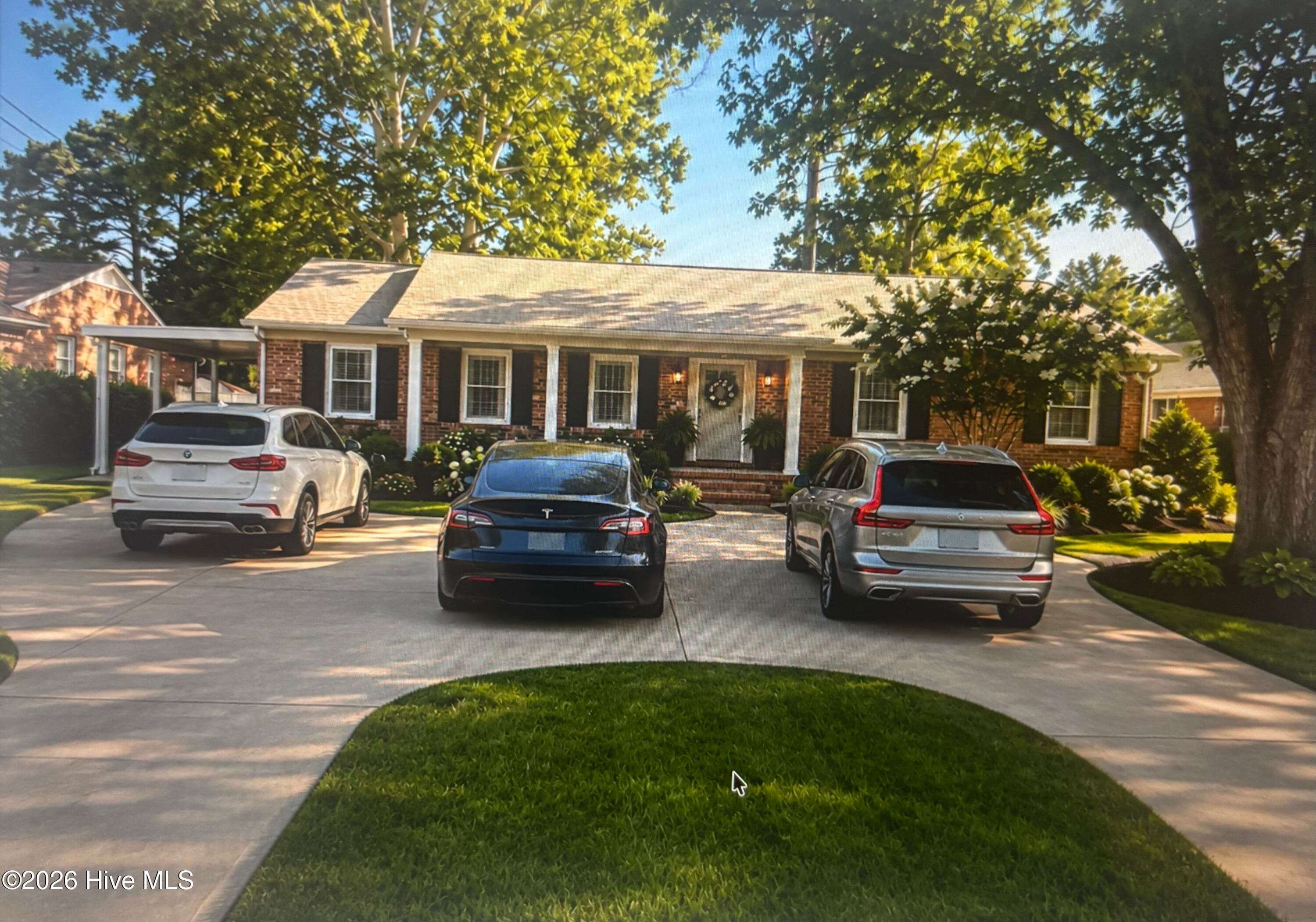 This photo has been AI generated to show a circle driveway added. - 2104 Charles Boulevard, Greenville, NC 27858