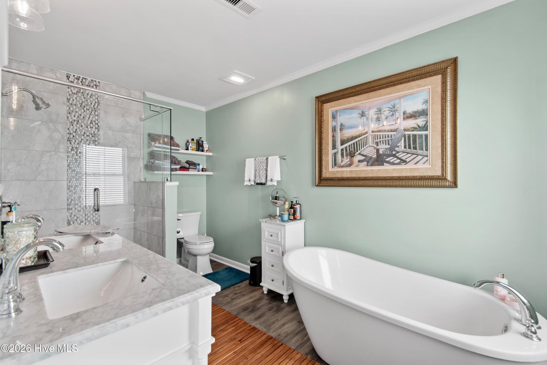 Primary en suite bathroom with soaking tub and tile shower. - 2024 Camelot Drive SW, Ocean Isle Beach, NC 28469