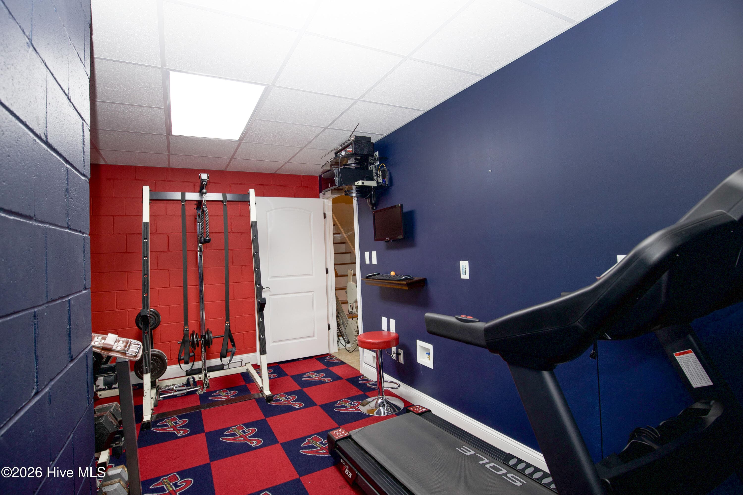 Exercise room with a door to the lower hall. - 899 Seagull Drive, Vass, NC 28394, Vass