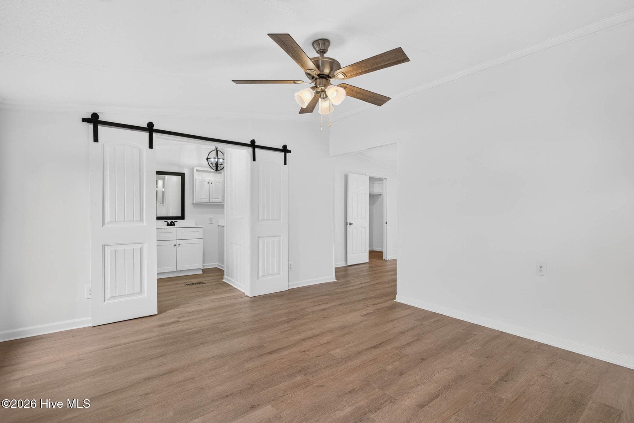 Retreat to the oversized primary suite featuring generous proportions, abundant natural light, and plenty of room for a private sitting area. - 1199 Zack Street SE, Bolivia, NC 28422