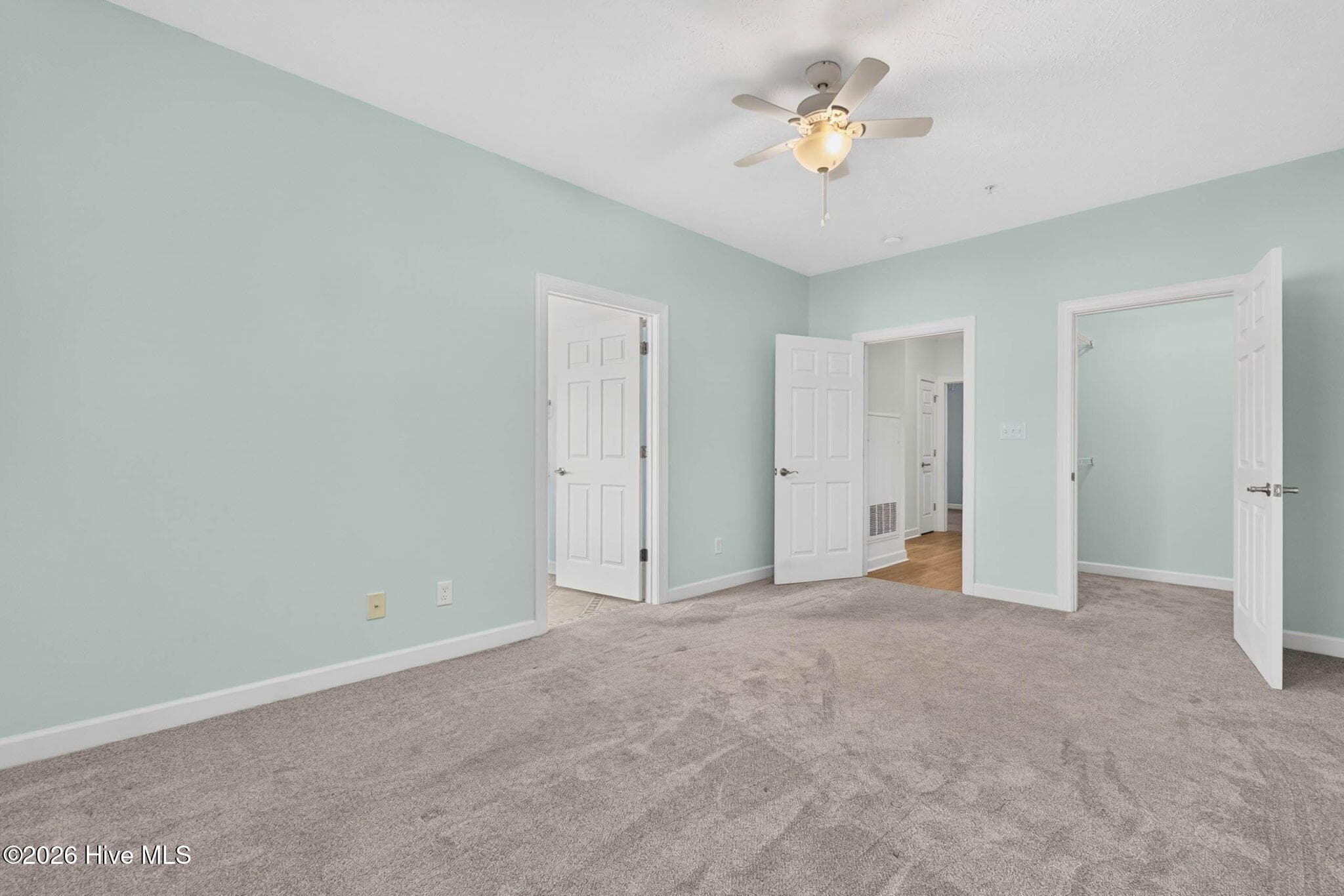 Primary bedroom with ensuite primary bathroom - 7825 High Market Street #303, Sunset Beach, NC 28468