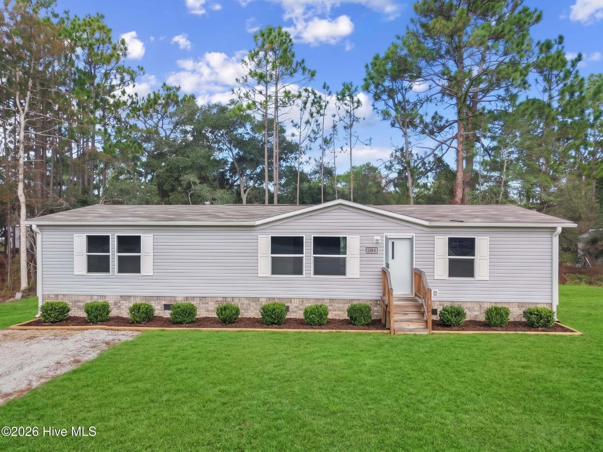 Photo is AI enhanced, owner installing new landscaping. - 3080 Cross Street SW, Shallotte, NC 28470