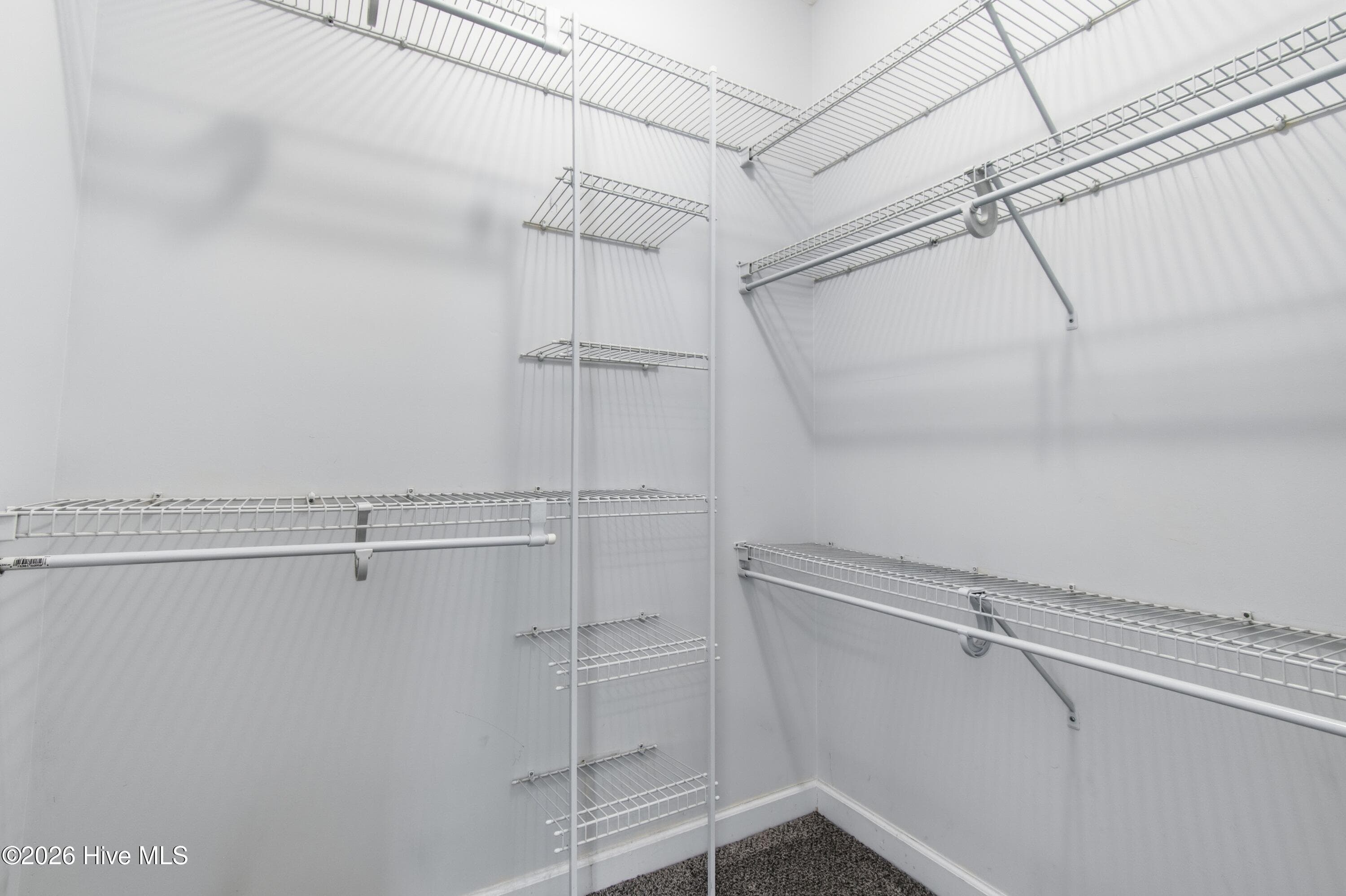 Walk-in closet located in primary suite. - 709 E Pipers Glen, Shallotte, NC 28470