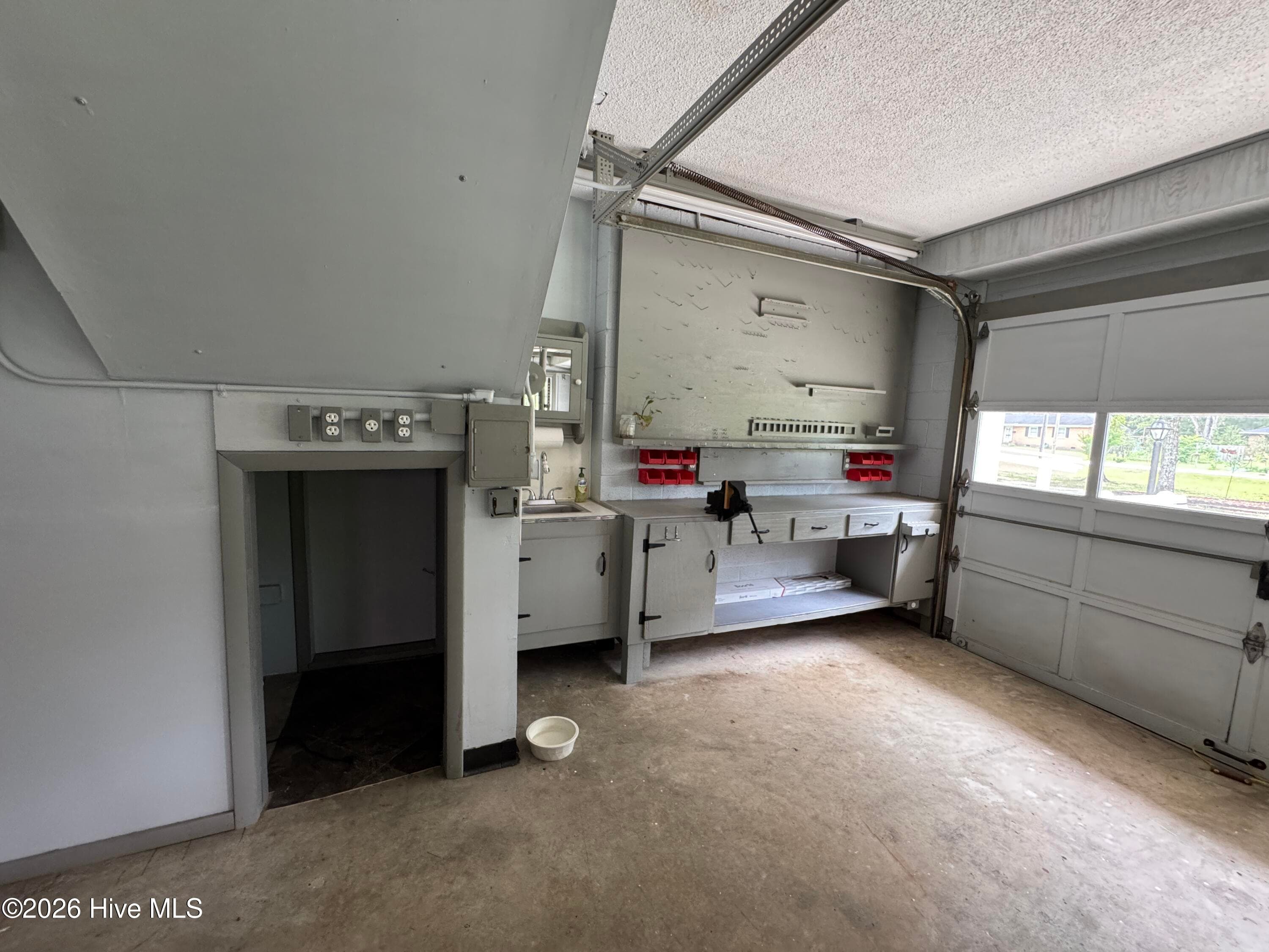Garage work space and the entrance to the crawl space. - 118 Oakwood Drive, Havelock, NC 28532