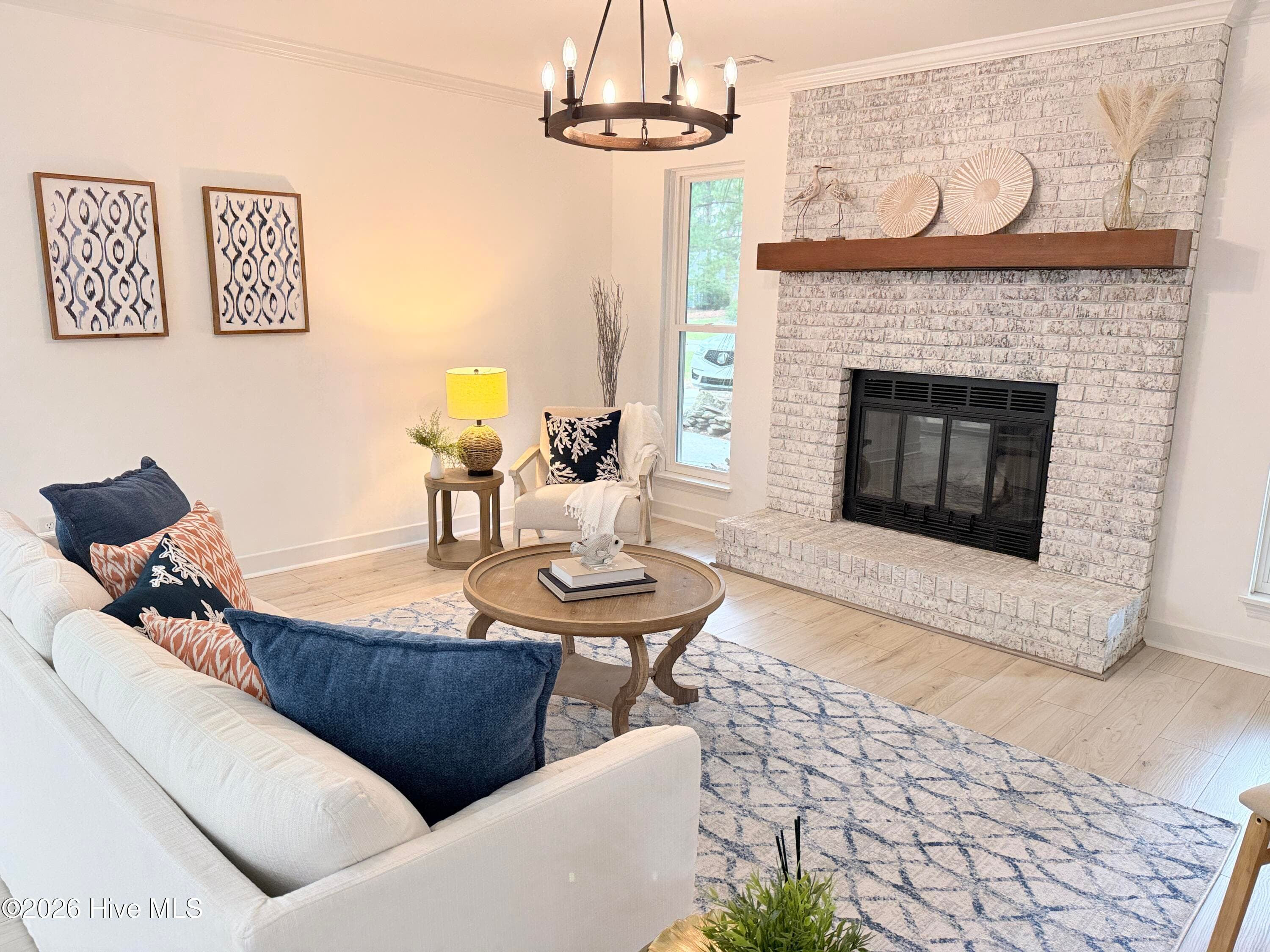 Limewashed brick fireplace with wooden mantle is gorgeous! - 1001 Hunting Ridge Road, Wilmington, NC 28412