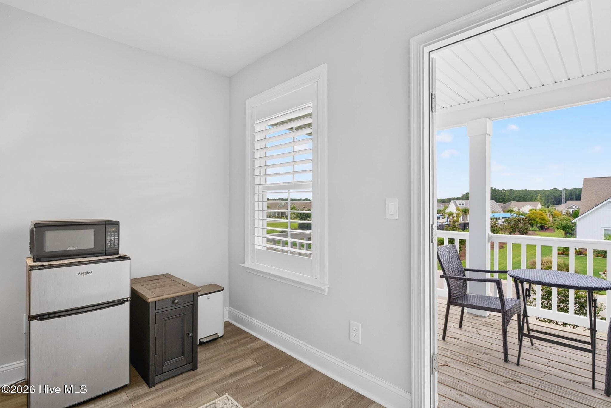 This bright secondary bedroom offers balcony access, natural light, and flexible space for family or overnight guests. - 139 Eagle Claw Drive, Calabash, NC 28467