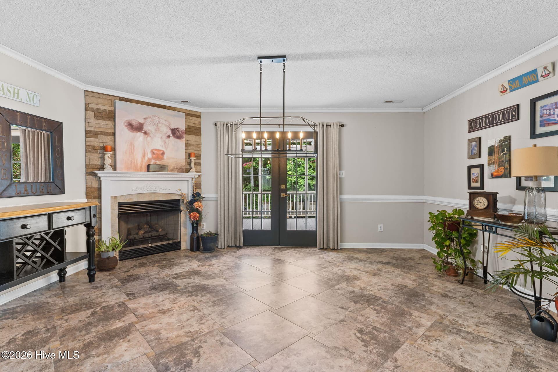 Living room with fireplace and glass doors opens to covered deck - 9184 Seaside Landing SW, Calabash, NC 28467