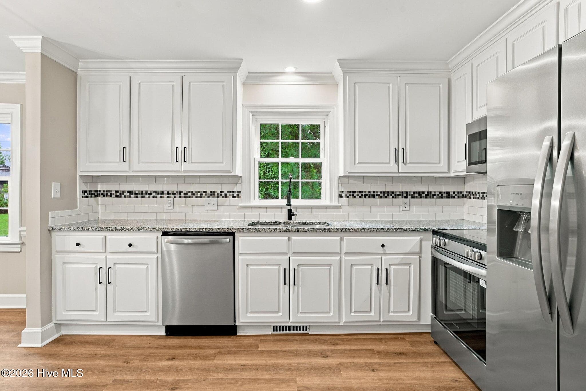 Updated kitchen with new flooring and cabinets - 2214 Somerset Drive N, Wilson, NC 27893