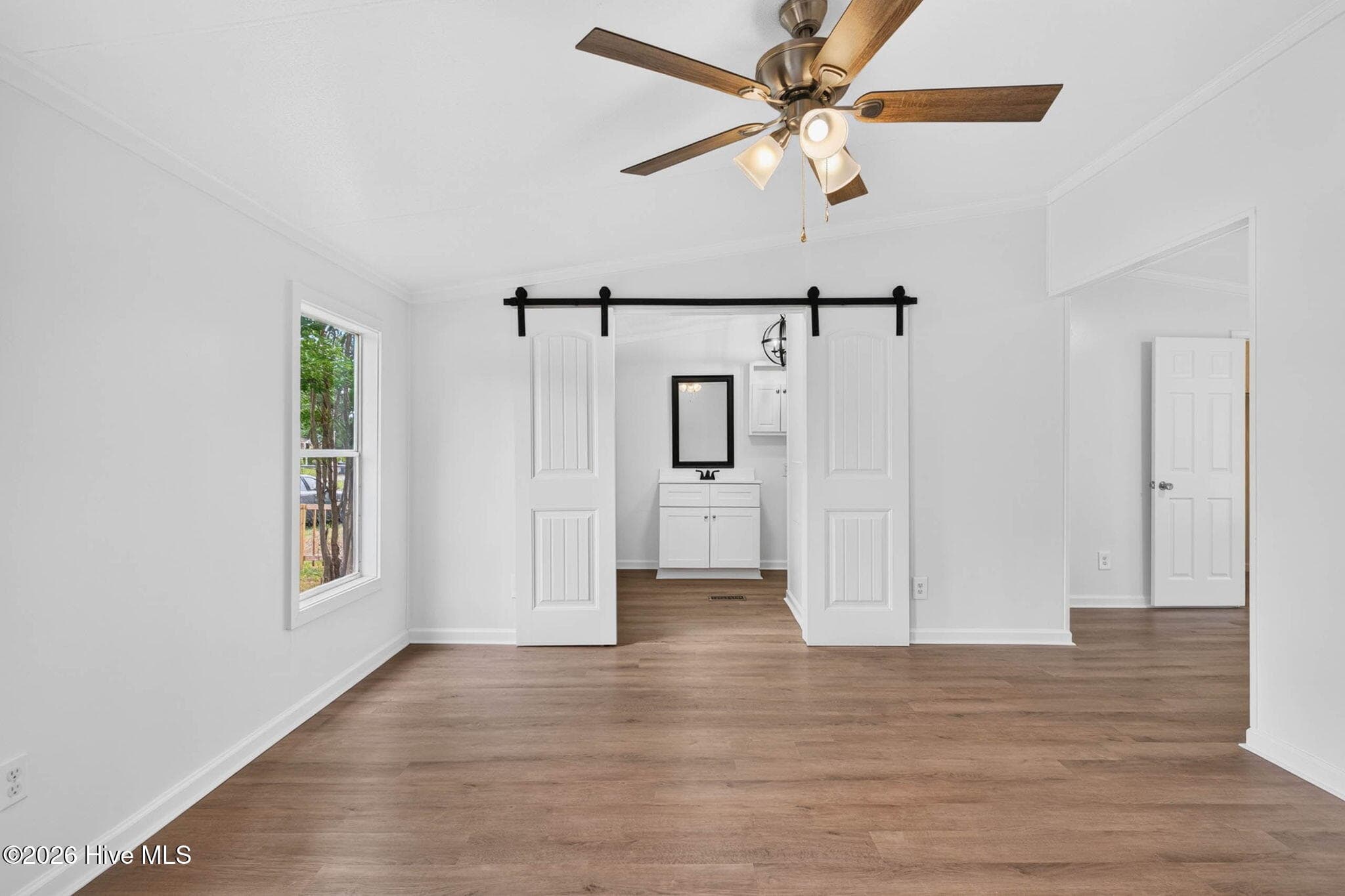 Oversized primary suite offers generous living space, luxury vinyl plank flooring, and endless possibilities for creating your own private retreat. - 1199 Zack Street SE, Bolivia, NC 28422
