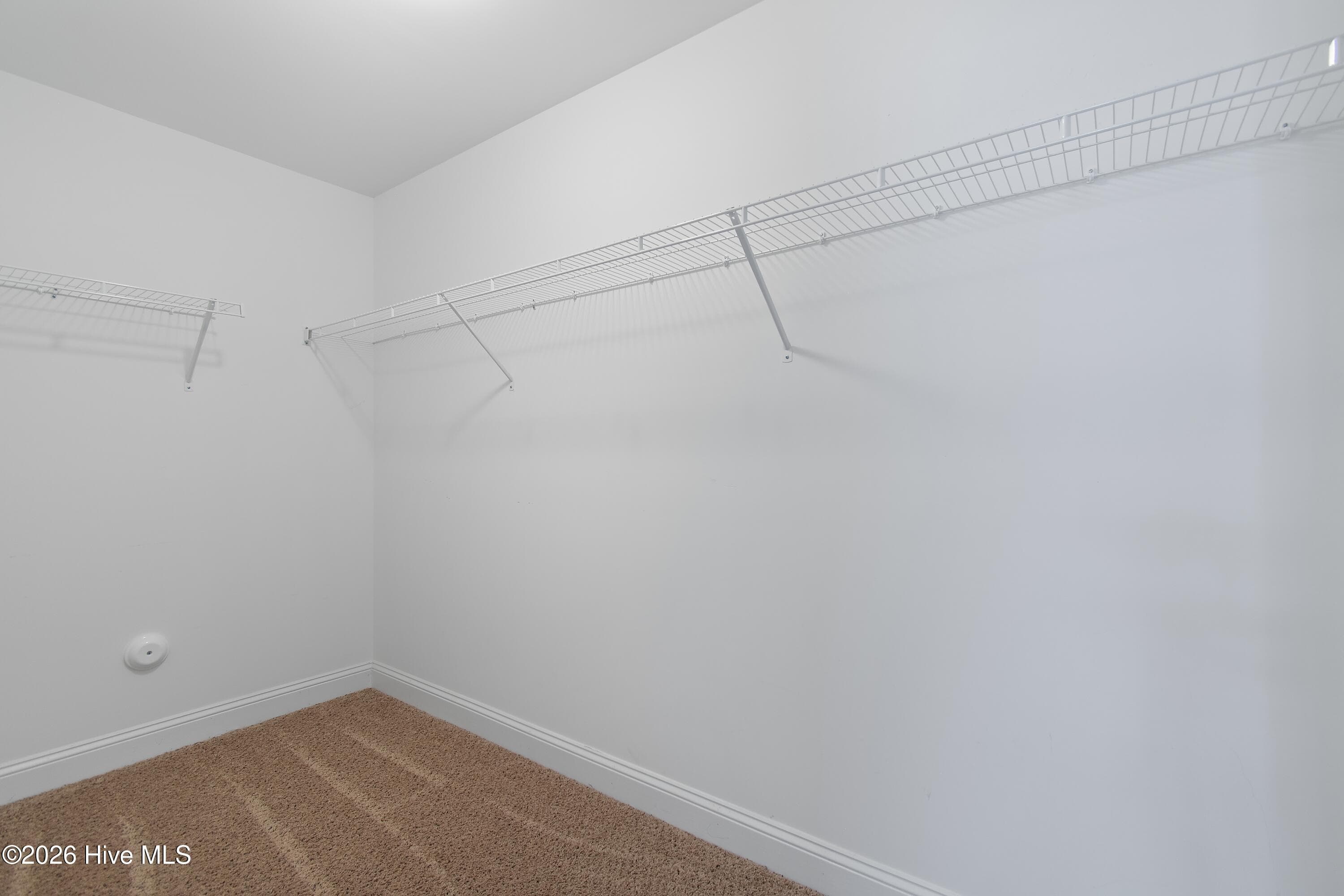 Primary suite walk-in closet #1. - 1674 Back Bay Drive SW, Shallotte, NC 28470