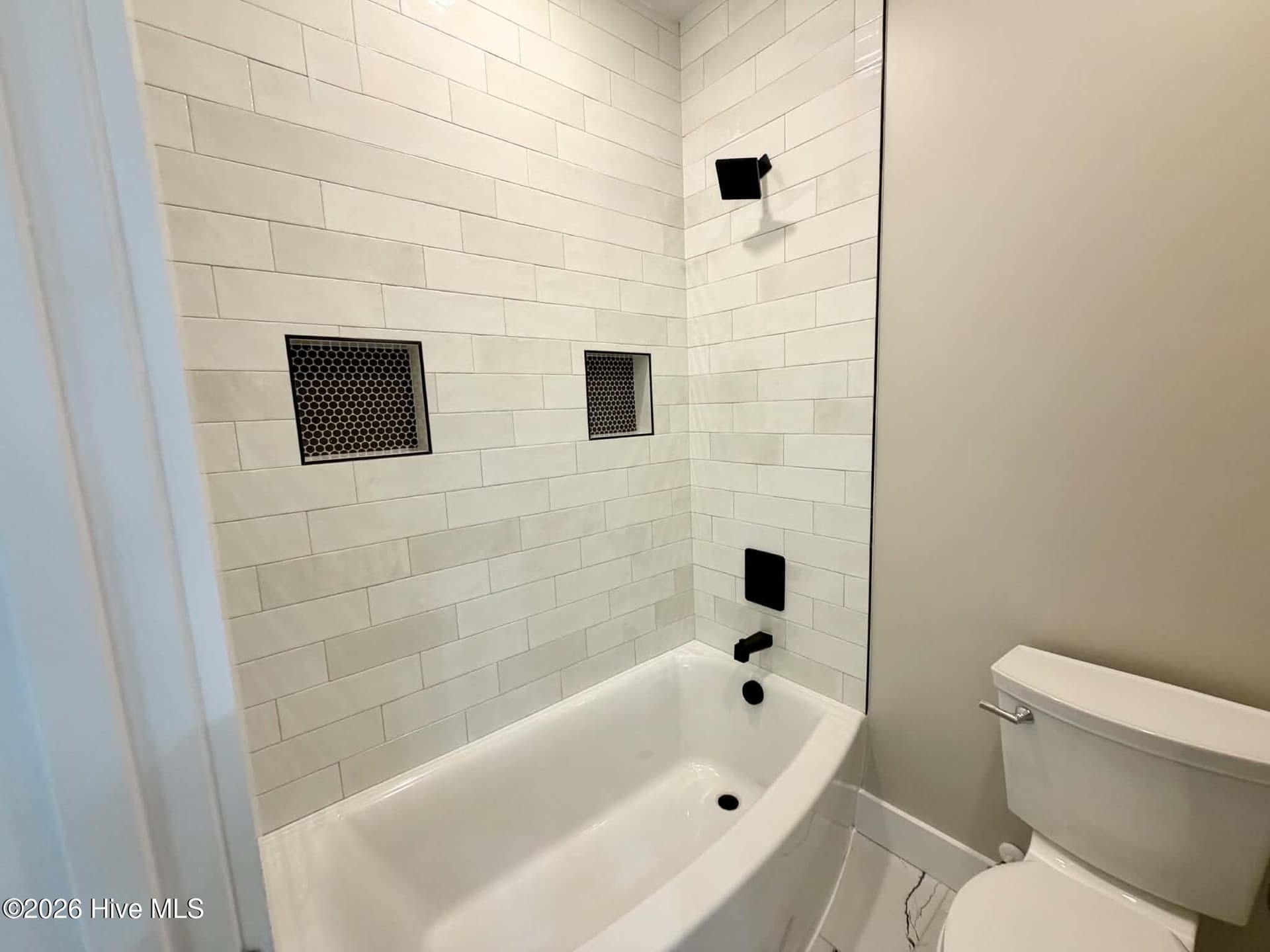 Guest bathroom upstairs, toilet and shower room. - 550 Glenburnie Street NW, Calabash, NC 28467