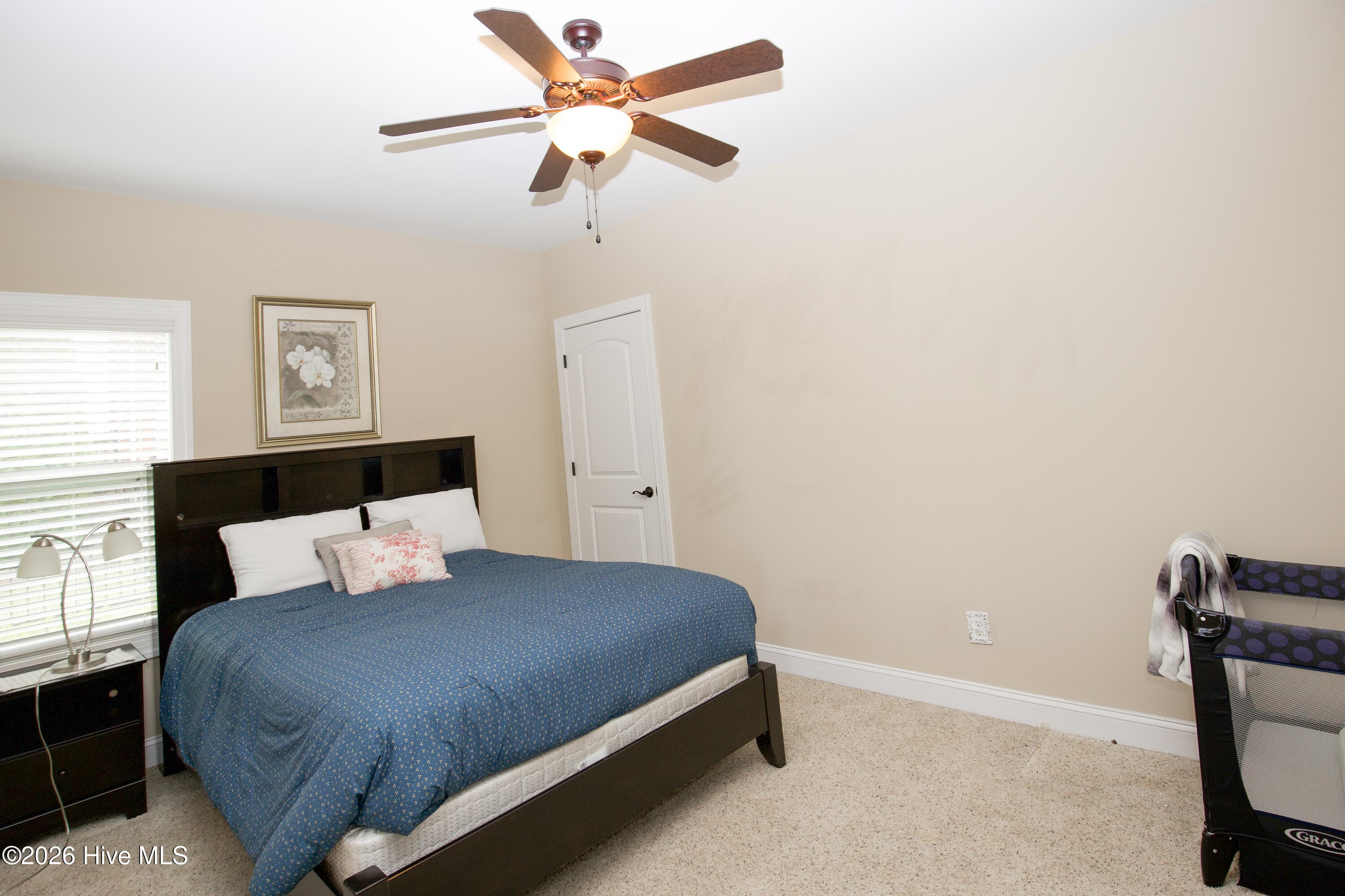Second lower-level bedroom with a ceiling fan and carpet. - 899 Seagull Drive, Vass, NC 28394, Vass