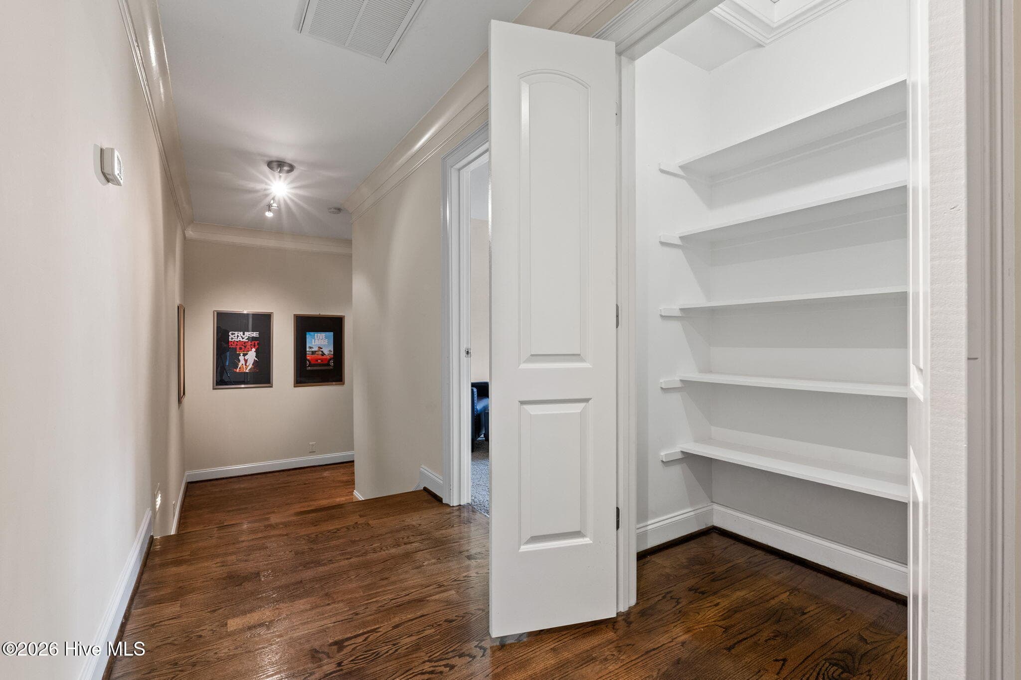 Hallway with large linen closet leads to media room - 3858 Ridge Crest Drive, Southport, NC 28461