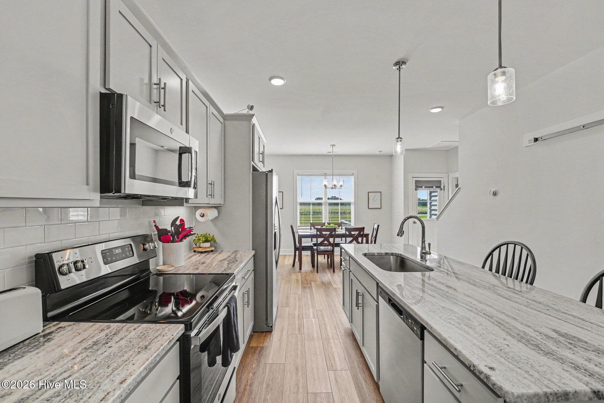 Kitchen with island, recessed lighting, and stainless steel appliances - 176 Glenwood Place, Kenly, NC 27542