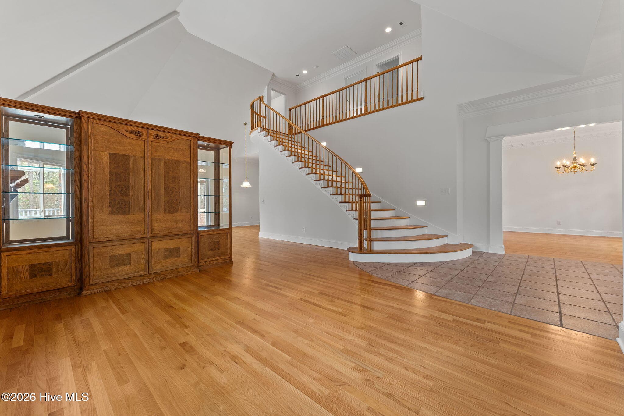 Living area with views of the dining room and upper living area. To the left, the entertainment center is movable if one chooses to have a great room. - 22 Lochmere Drive, Pinehurst, NC 28374
