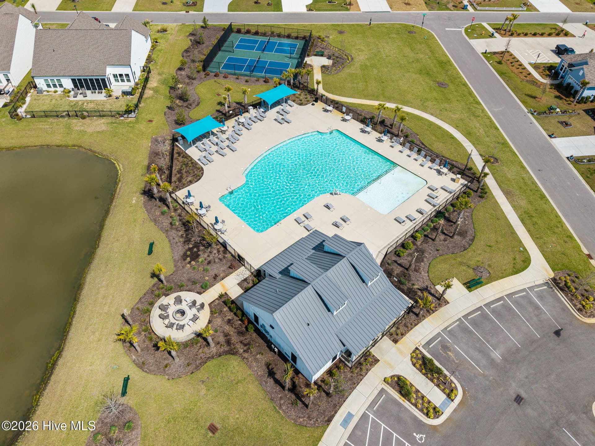 The neighborhood amenity center features a spacious swimming pool, pool deck, clubhouse, and nearby pickleball courts. - 139 Eagle Claw Drive, Calabash, NC 28467