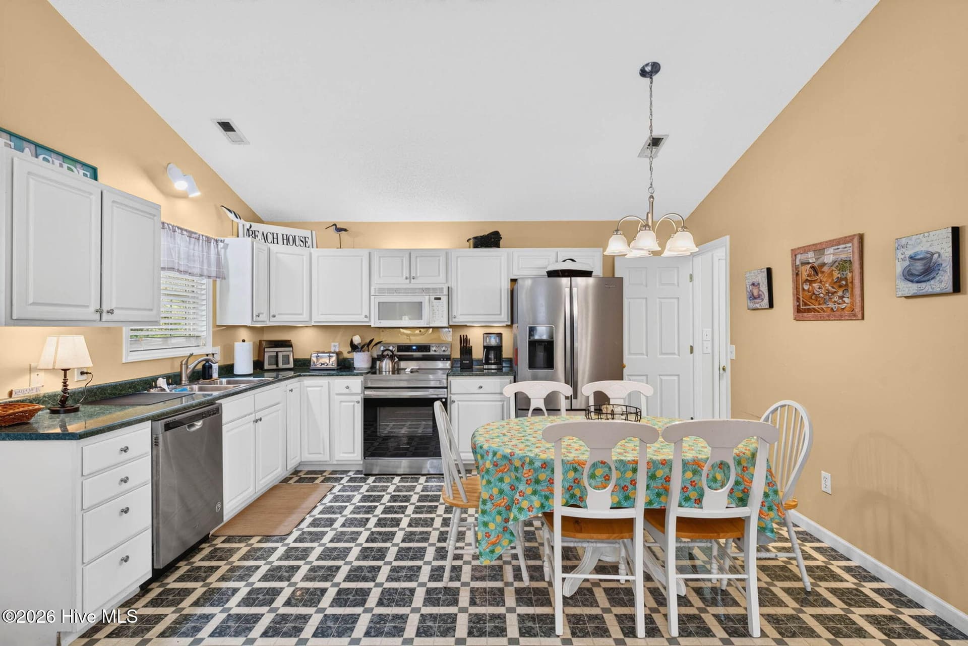 Open kitchen and dining area offers a functional setup for everyday meals, entertaining, or vacation stays. - 1650 Frink Street SW, Ocean Isle Beach, NC 28469