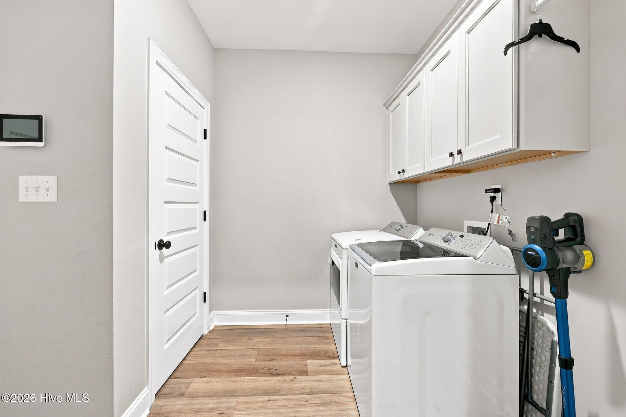 Laundry room with additional storage closet with shelving - 2212 Marinwood Court, Greenville, NC 27834