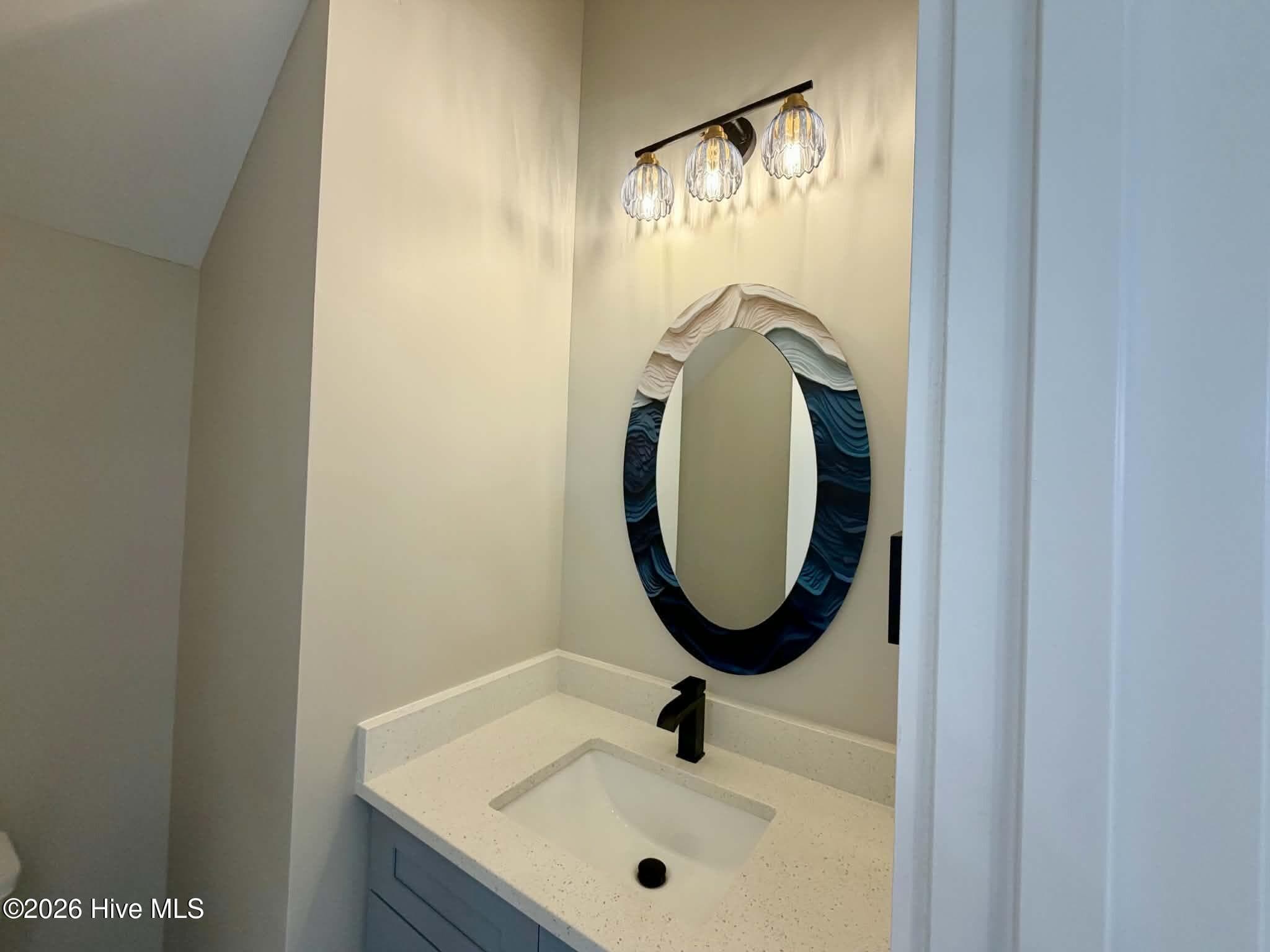 Powder room half bath, custom mirror and lighting. - 550 Glenburnie Street NW, Calabash, NC 28467