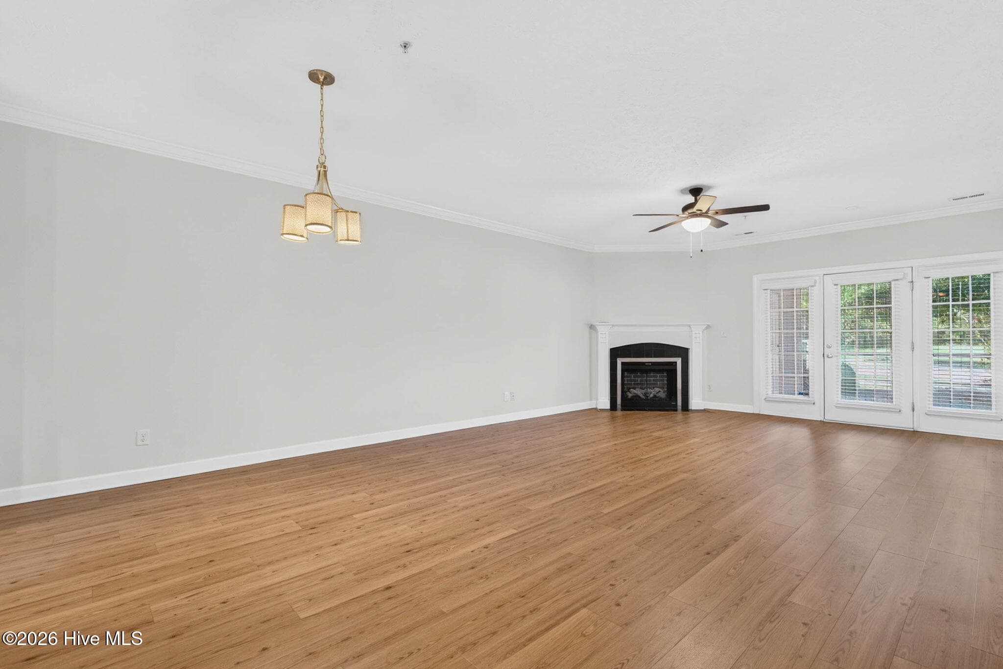 Dining room (see chandelier) and living room with fireplace - 7825 High Market Street #303, Sunset Beach, NC 28468