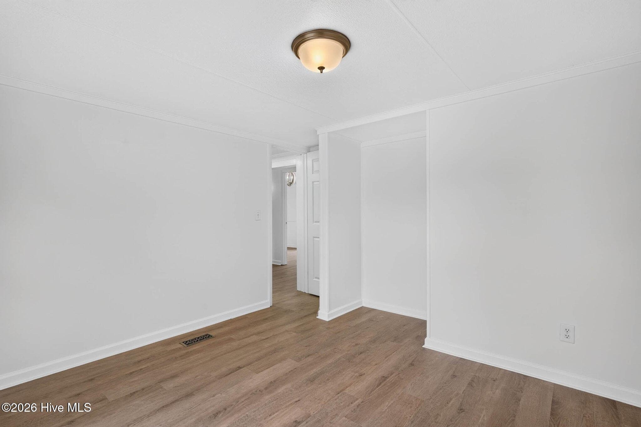 Well-proportioned bedroom featuring luxury vinyl plank flooring and a neutral color palette that's ready for your personal touch. - 1199 Zack Street SE, Bolivia, NC 28422