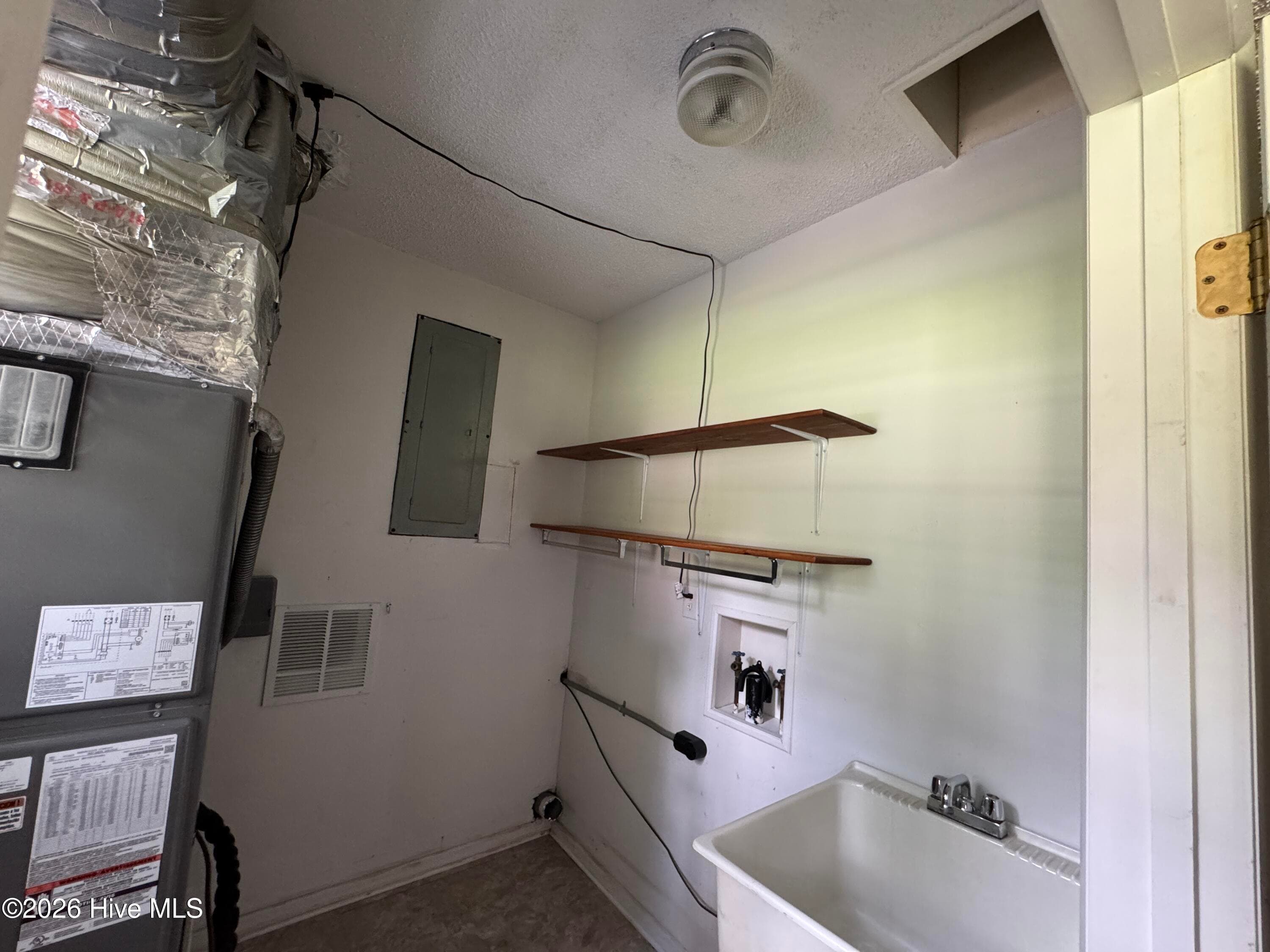 Mud room with Air Handler, Sink, Washer/Dryer and a Laundry Chute (over sing). - 118 Oakwood Drive, Havelock, NC 28532