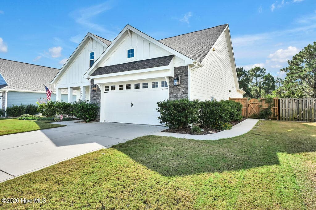 You'll love this added private sidewalk connecting the driveway to the backyard gate for a no-fuss transition. - 142 Rice Marsh Way, Wilmington, NC 28412
