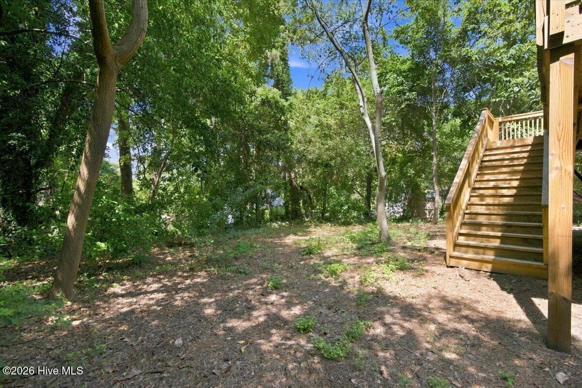 Fenced yard and deck stairs down to yard - 160 N Ridge Street, Southern Pines, NC 28387