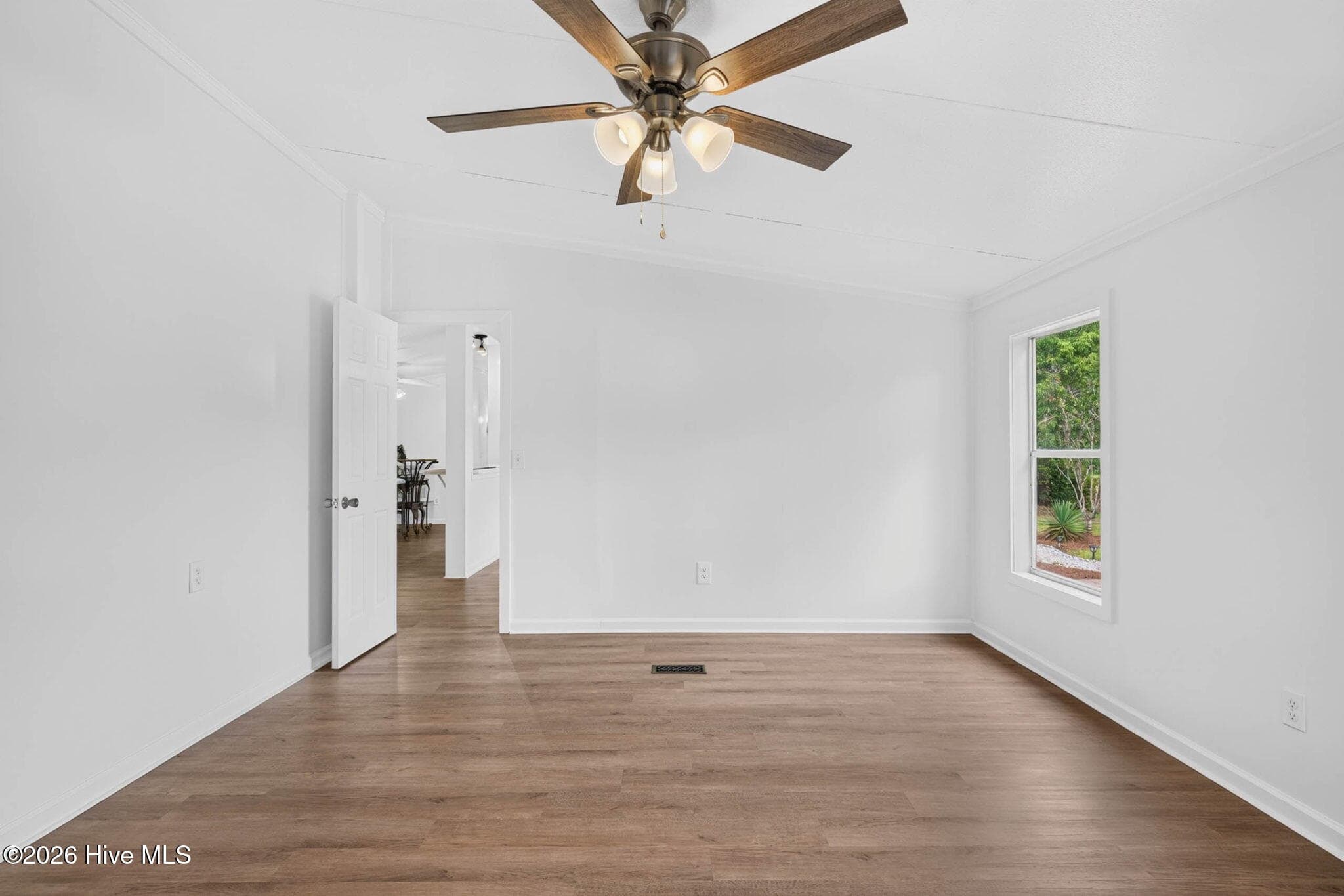 The spacious primary bedroom easily accommodates large furniture while maintaining an open, airy feel filled with natural light. - 1199 Zack Street SE, Bolivia, NC 28422