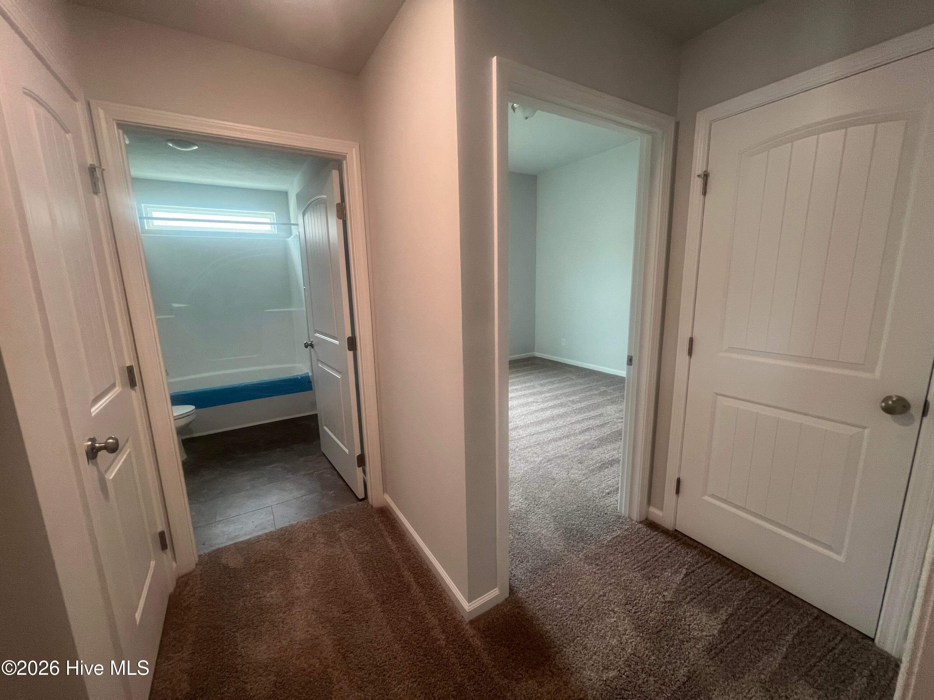 Hallway between the bedrooms # 2 & 3 and full bathroom. Storage closet on your right. - 8887 Snelling Drive, Aiken, SC 29803