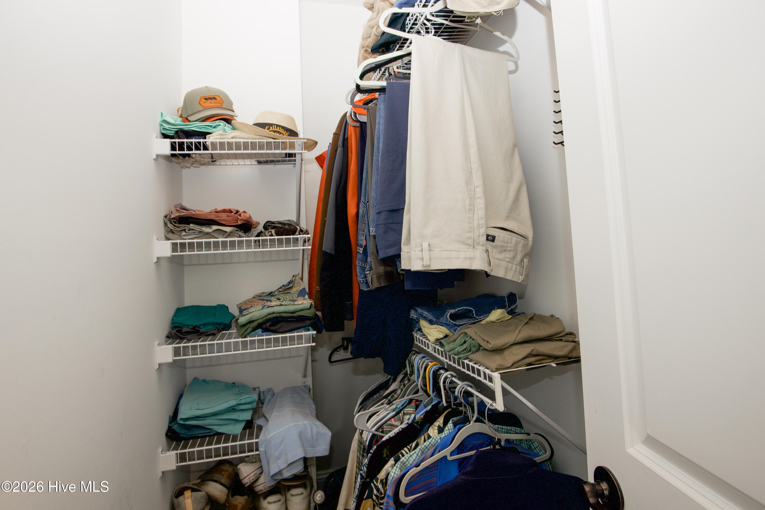 Second walk-in closet in the primary suite, with wire shelving. - 899 Seagull Drive, Vass, NC 28394, Vass