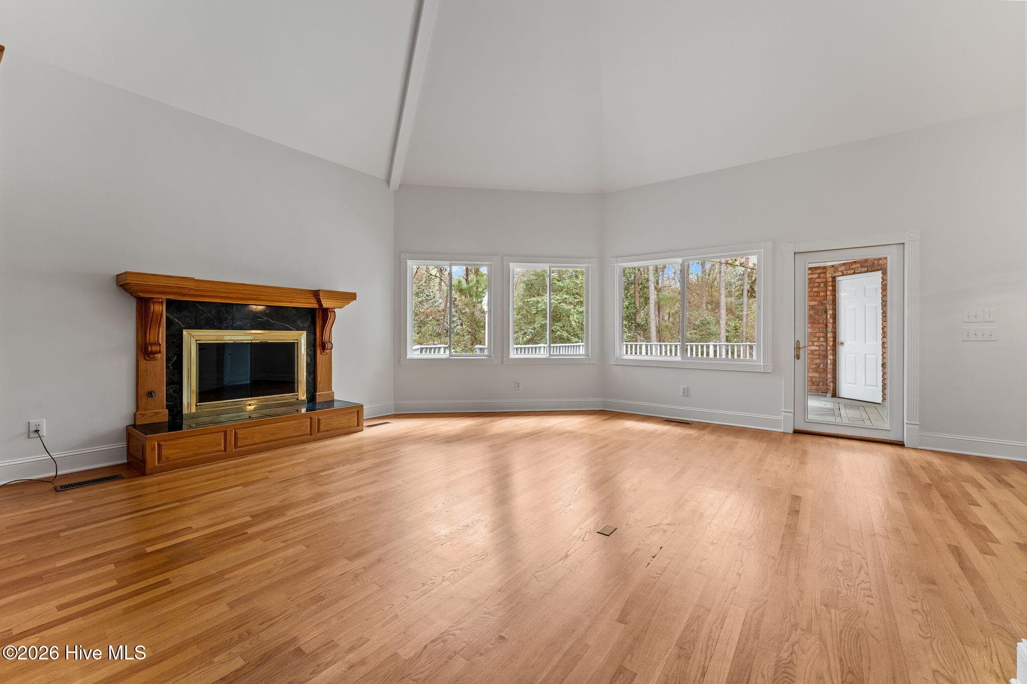 Family living area with a fireplace and access to the deck and to the right is the gourmet kitchen. - 22 Lochmere Drive, Pinehurst, NC 28374