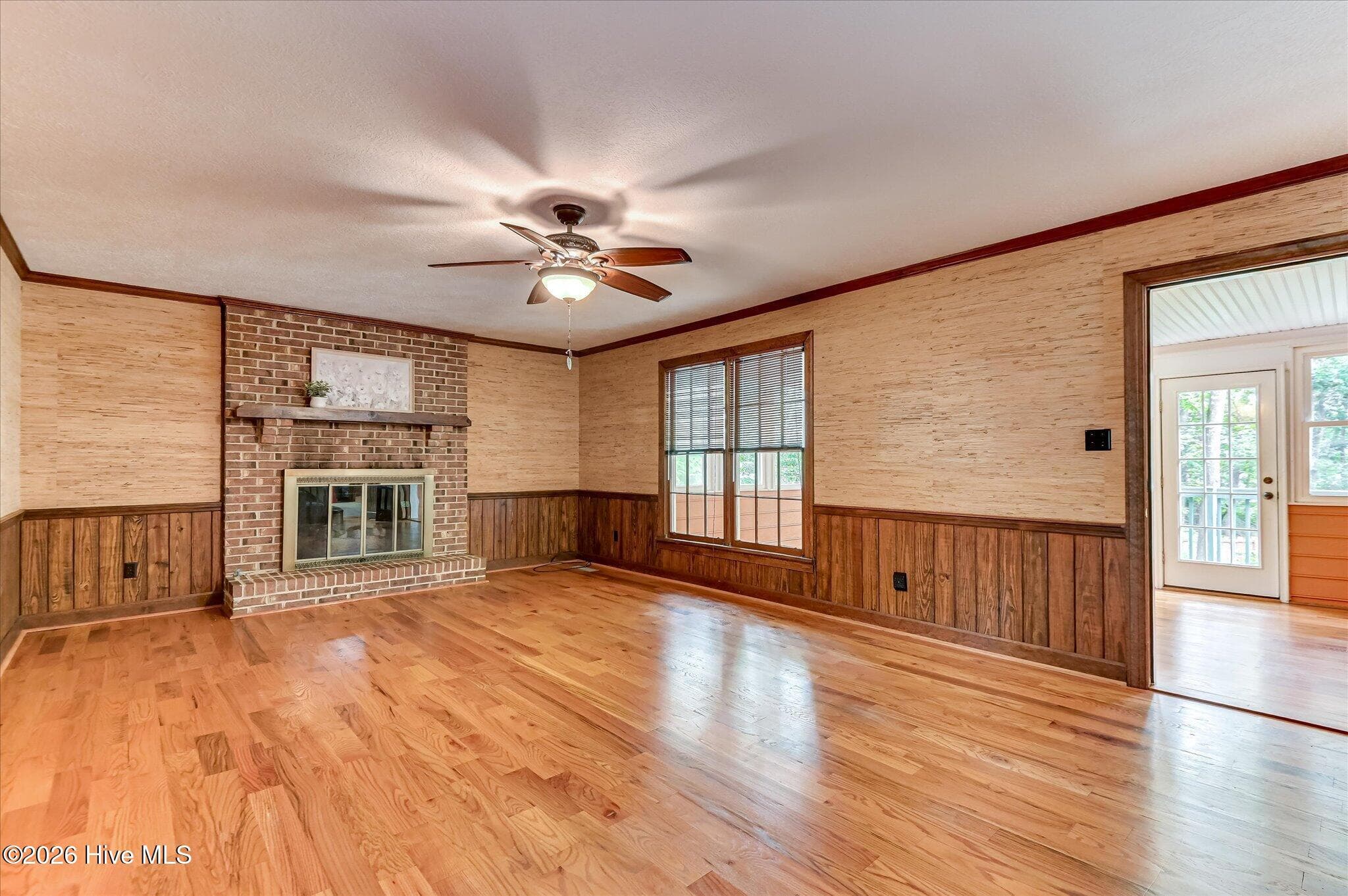 The Family Room features a brick fireplace and opens to a bright sunroom, perfect for morning coffee or winding down. - 307 Wakefield Lane N, Martinez, GA 30907