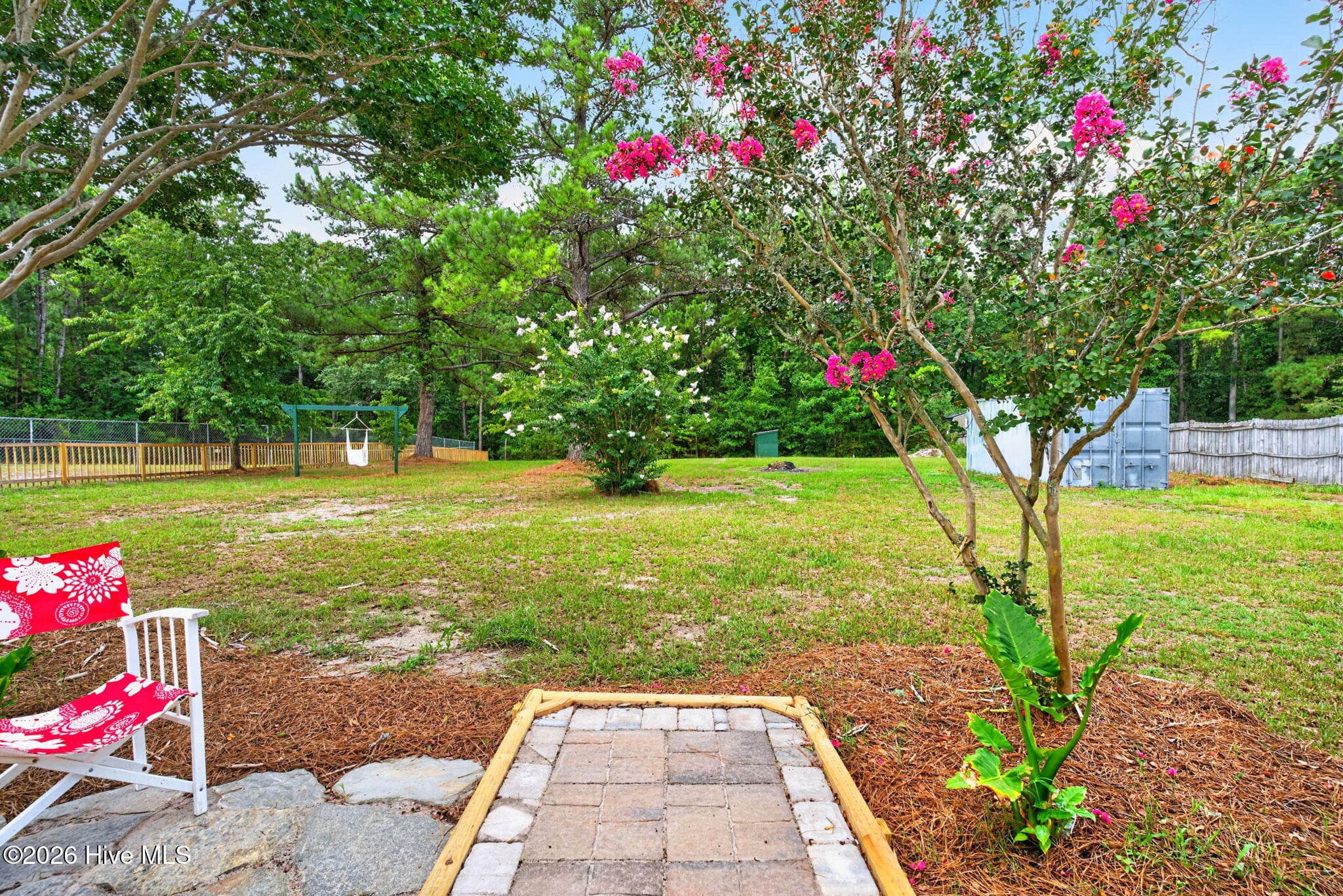 Step outside to a beautifully landscaped backyard featuring a patio that's perfect for relaxing, entertaining, or enjoying peaceful evenings outdoors. - 1199 Zack Street SE, Bolivia, NC 28422