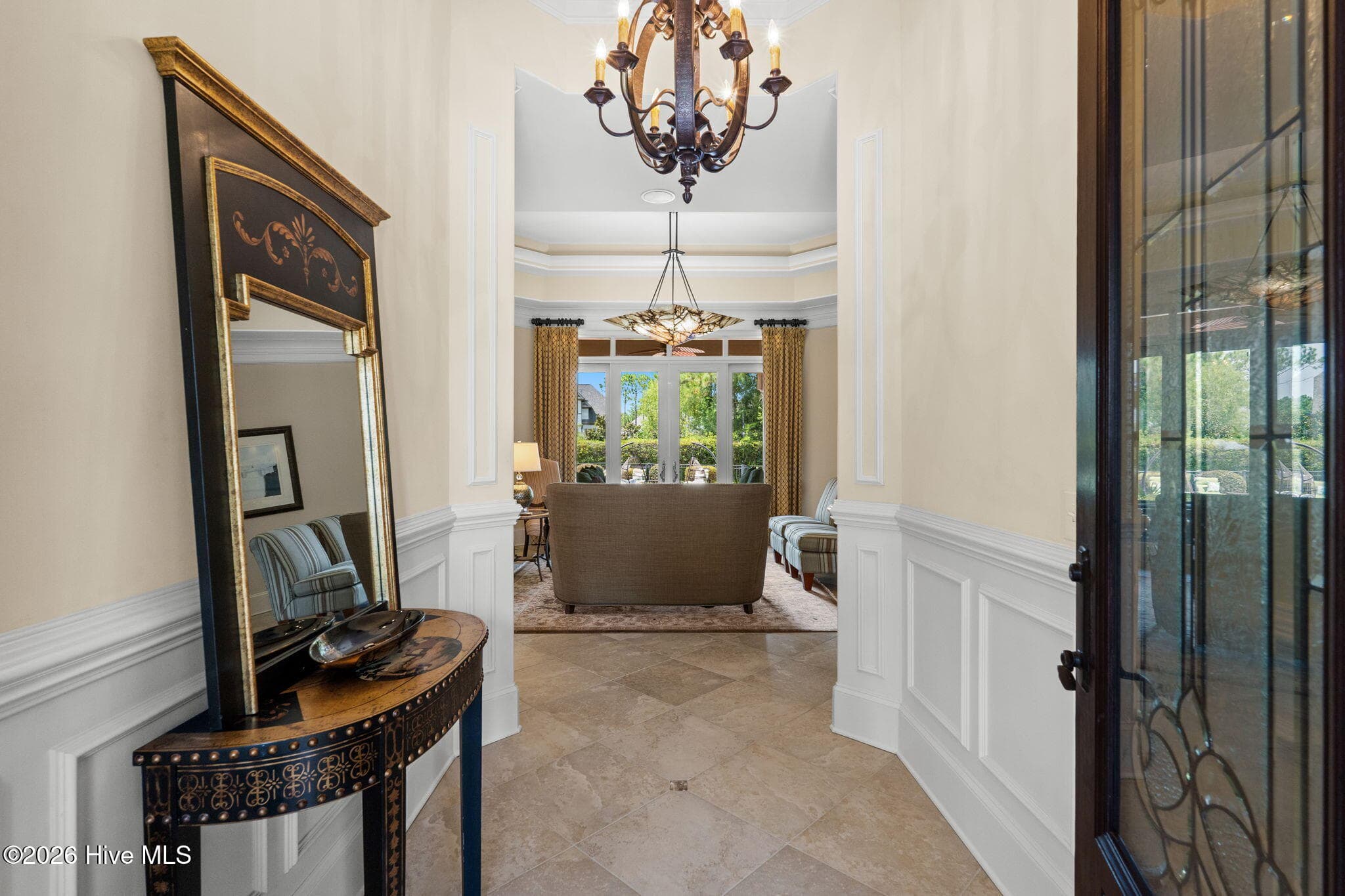 Foyer with beautiful ceramic tile. high ceiling and library panels - 3858 Ridge Crest Drive, Southport, NC 28461