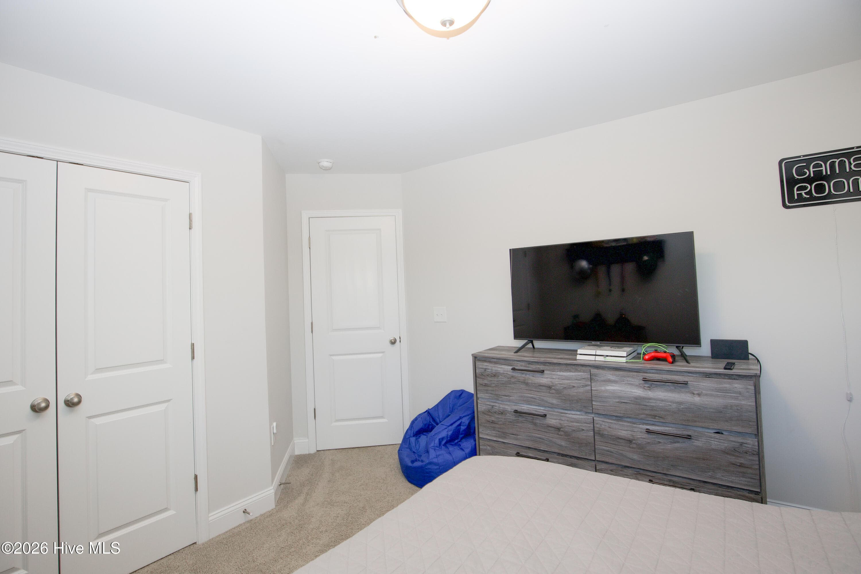 The second bedroom offers carpet, a ceiling light, and a double-door closet beside the entry door. There is room for a bed, a dresser, and a desk or chair. Like the other upstairs bedrooms, it shares the hall with the second full bath and the laundry room. - 221 Vega Lane, Linden, NC 28356