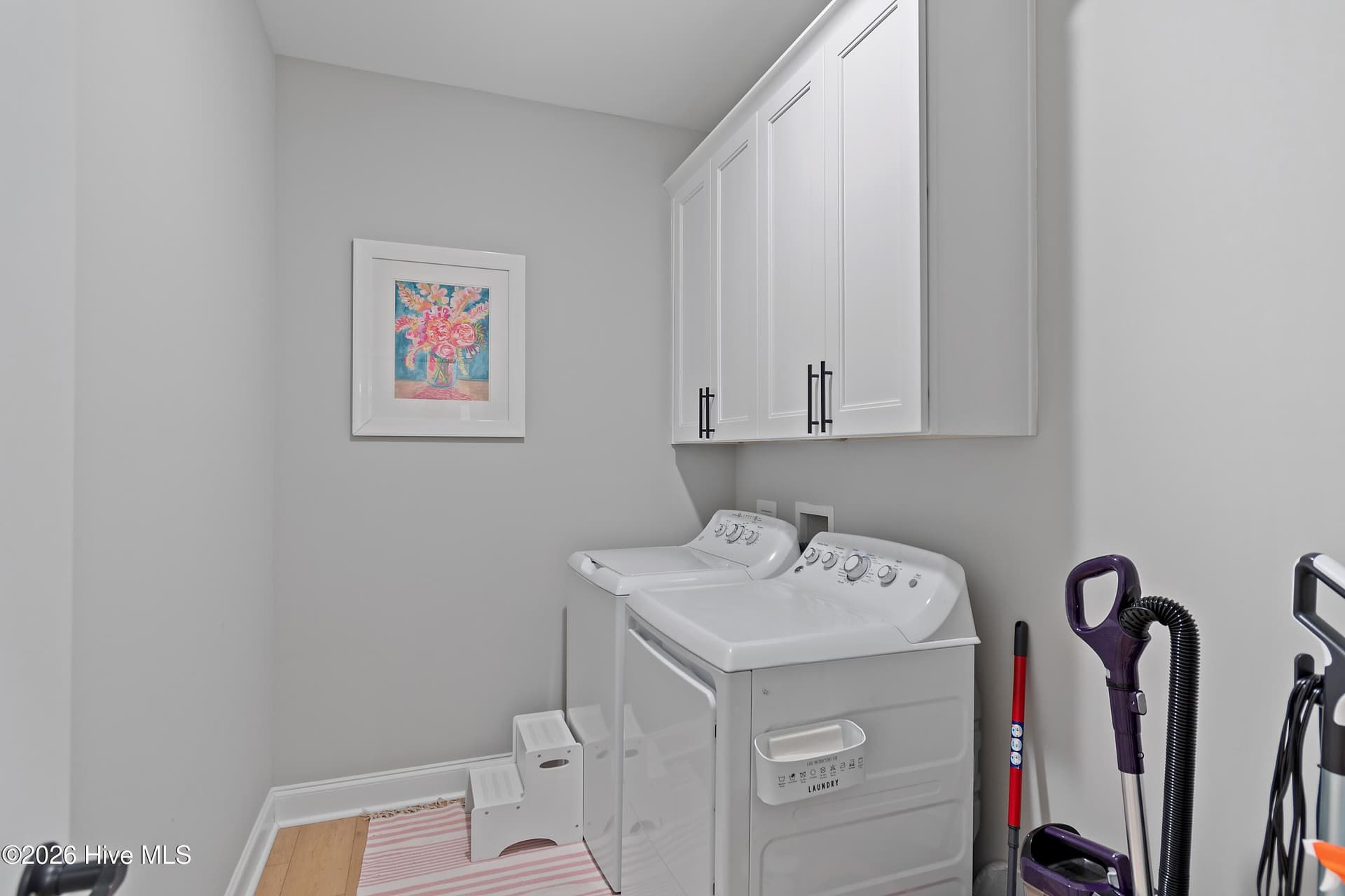 Enjoy the convenience of a dedicated laundry room complete with built-in cabinets for added storage and organization. The washer and dryer convey with the home, making move-in easy and everyday living even more convenient. - 299 Boundaryline Drive NW, Calabash, NC 28467
