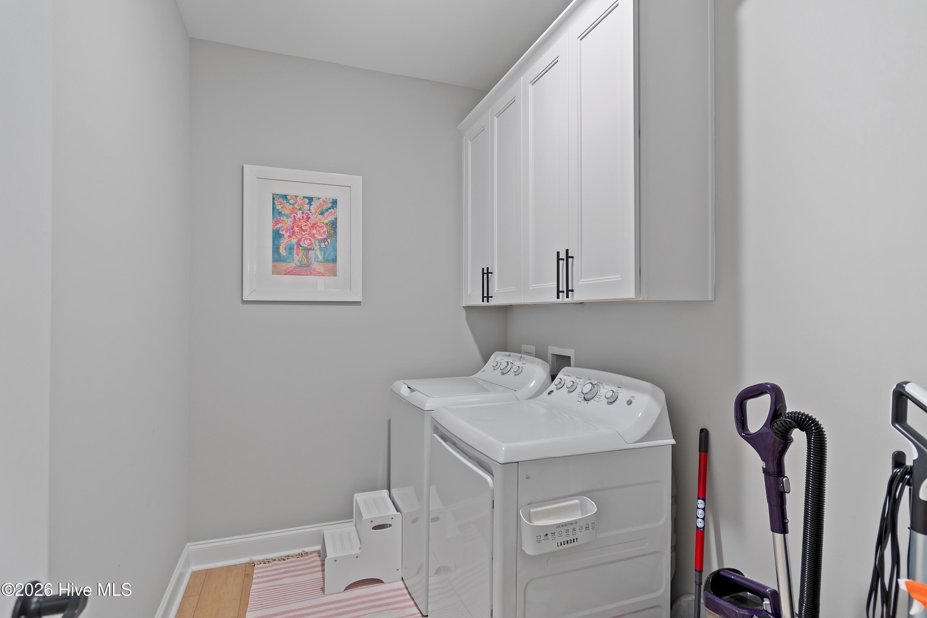 Enjoy the convenience of a dedicated laundry room complete with built-in cabinets for added storage and organization. The washer and dryer convey with the home, making move-in easy and everyday living even more convenient. - 299 Boundaryline Drive NW, Calabash, NC 28467