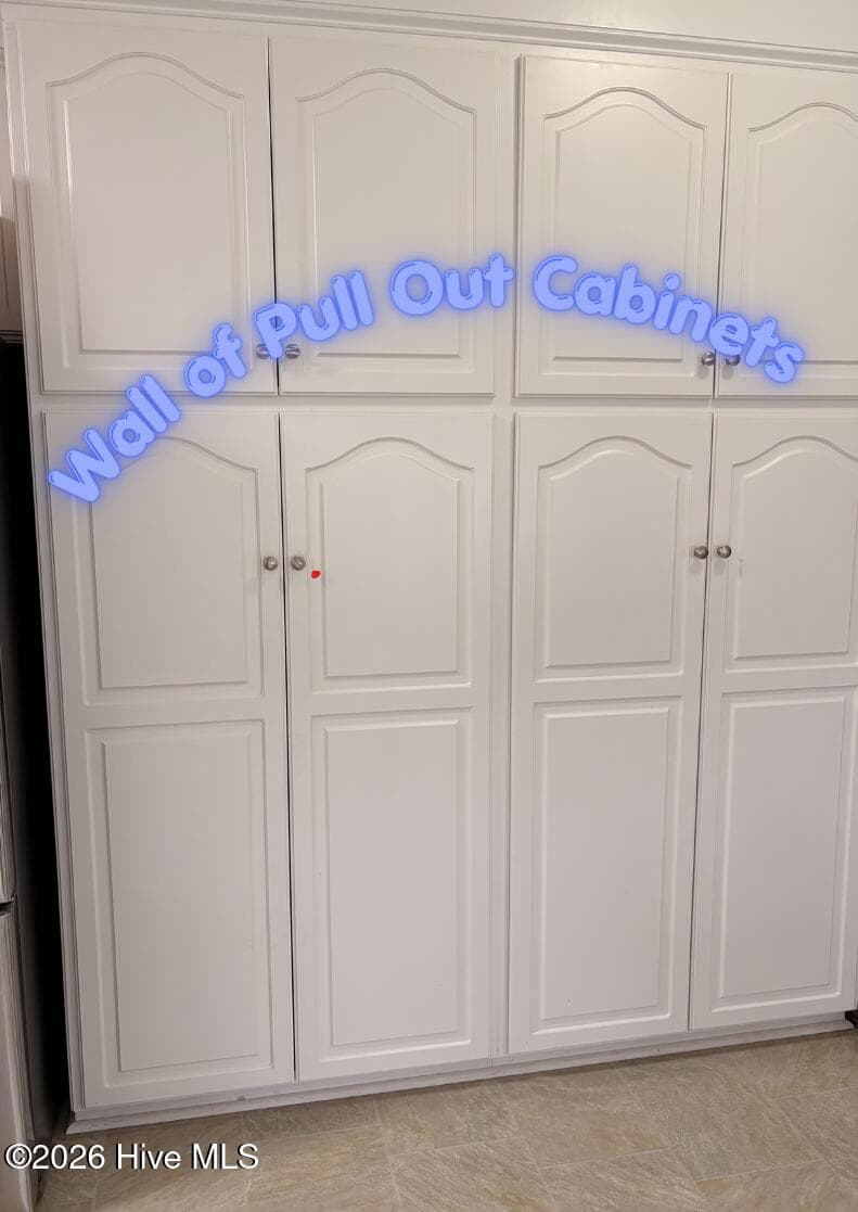Wall of pull-out pantry cabinets - 105 Pointe Drive, La Grange, NC 28551