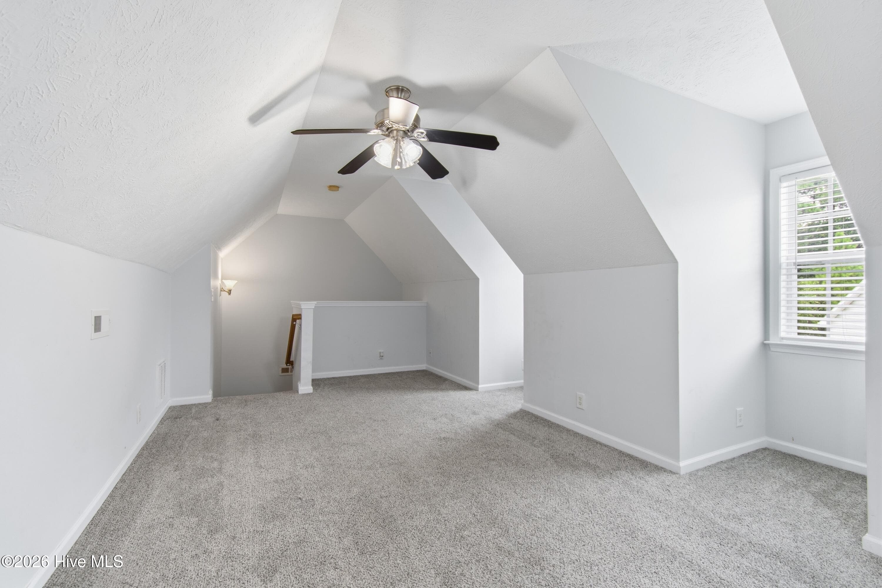 Upstairs, room above the garage. Plenty of windows for a bright feel. - 709 E Pipers Glen, Shallotte, NC 28470