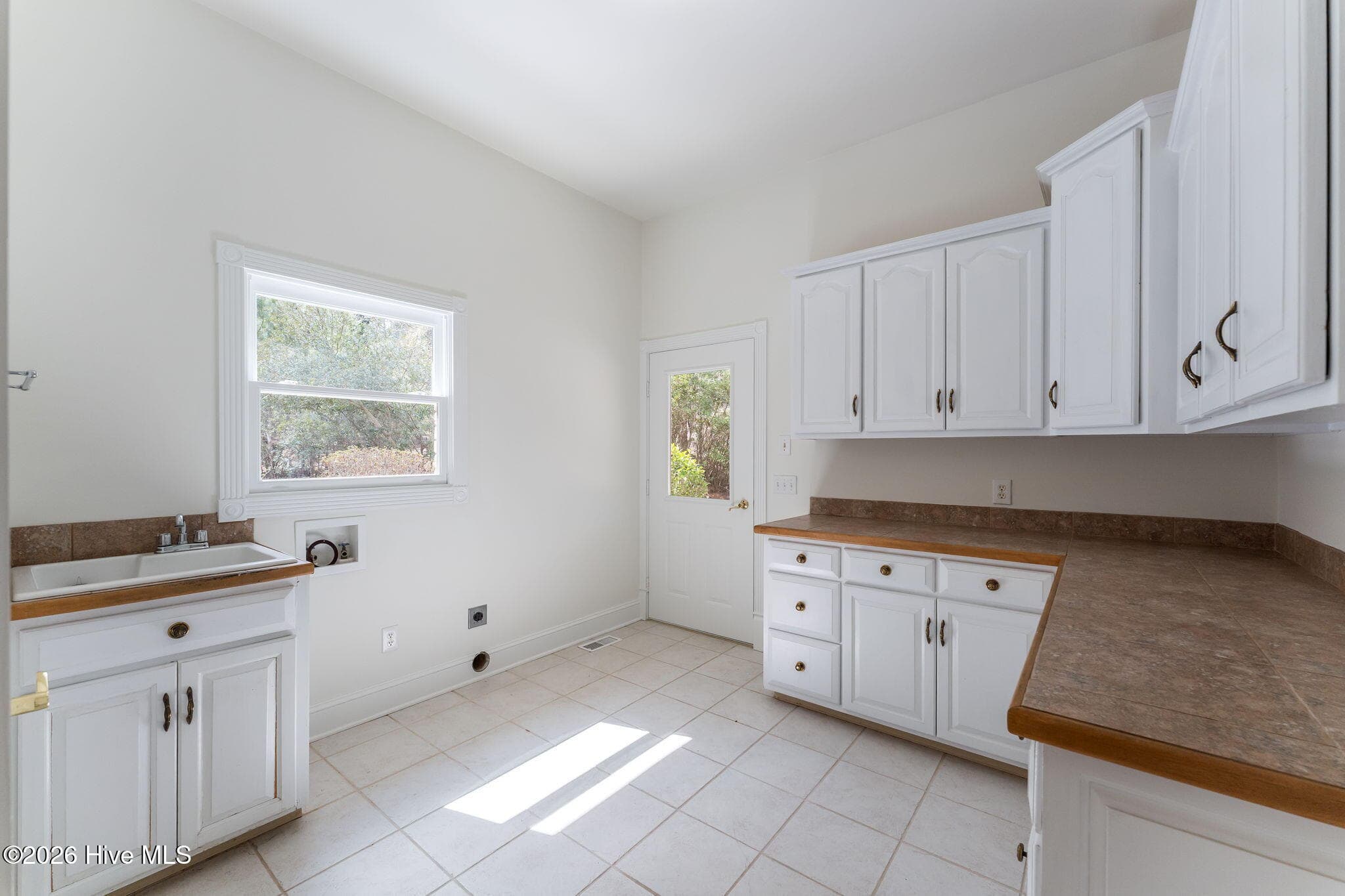 Laundry/mud room. Plenty of cabinets and closet for storage. Clean off here before further entry. - 22 Lochmere Drive, Pinehurst, NC 28374