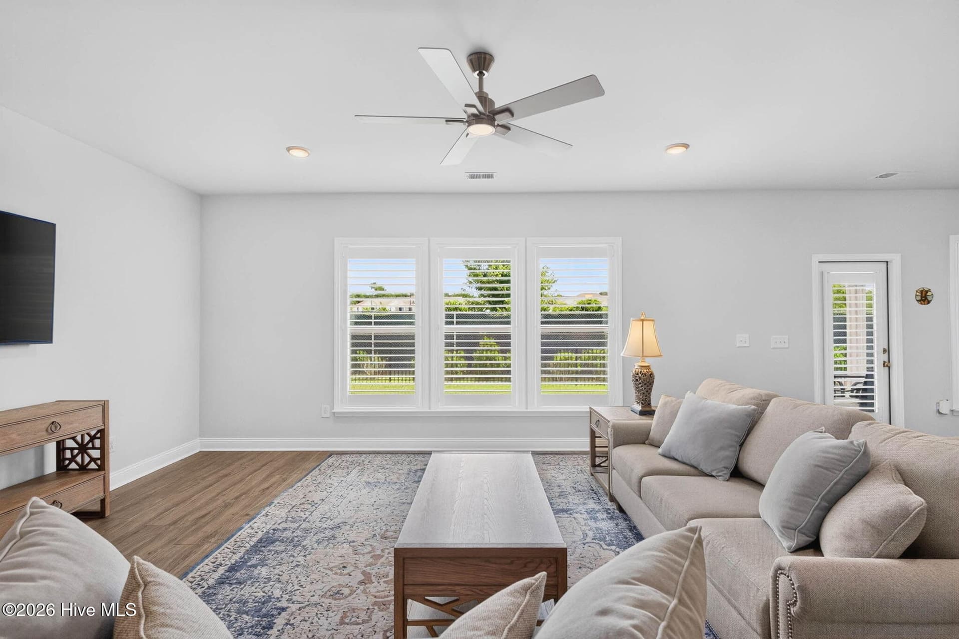 The spacious gathering room features abundant natural light and views of the backyard and golf-course setting. - 139 Eagle Claw Drive, Calabash, NC 28467