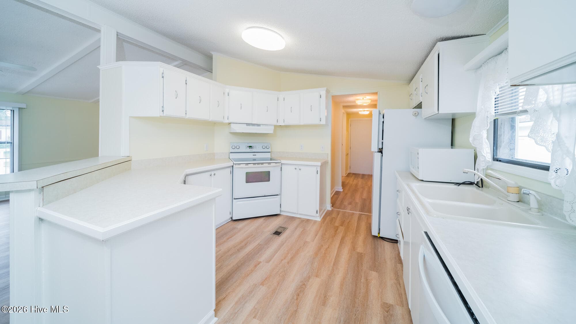The double level kitchen bar provides seating and extra prep space - 1076 Clubview Lane SW, Calabash, NC 28467