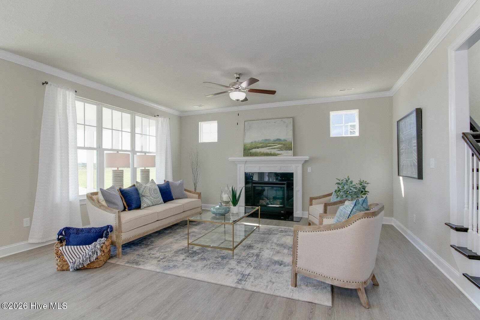 Sample photo of family room, which is open to kitchen; comes with natural gas fireplace and ceiling fan; note large triple windows - 122 Arbormoor Lane, Moyock, NC 27958