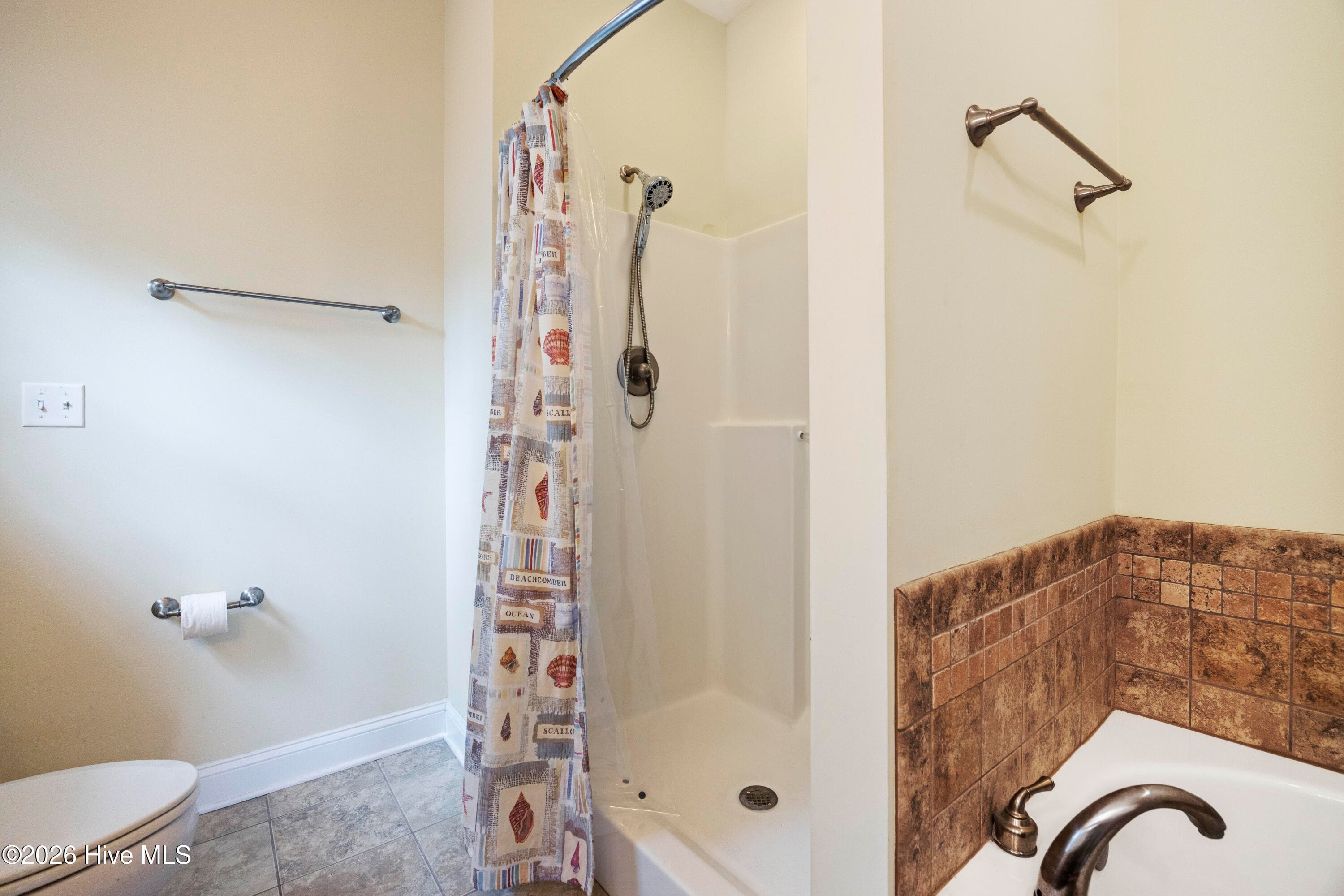 PRIMARY BEDROOM's En Suite Bathroom features jetted Step-In Shower - 225 NE 39th Street, Oak Island, NC 28465
