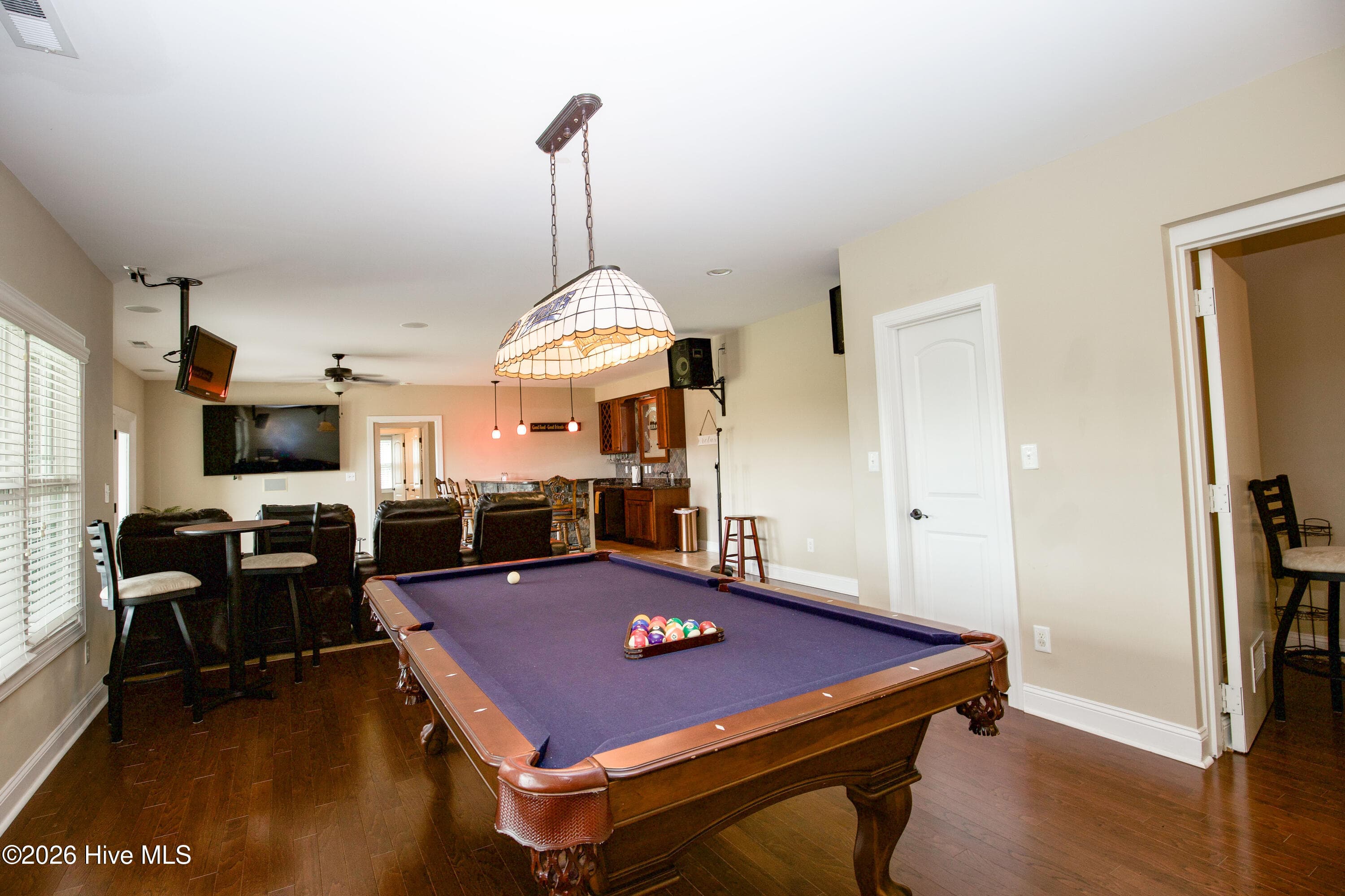 Recreation room with windows along the rear wall. Pool table conveys with an acceptable offer. - 899 Seagull Drive, Vass, NC 28394, Vass