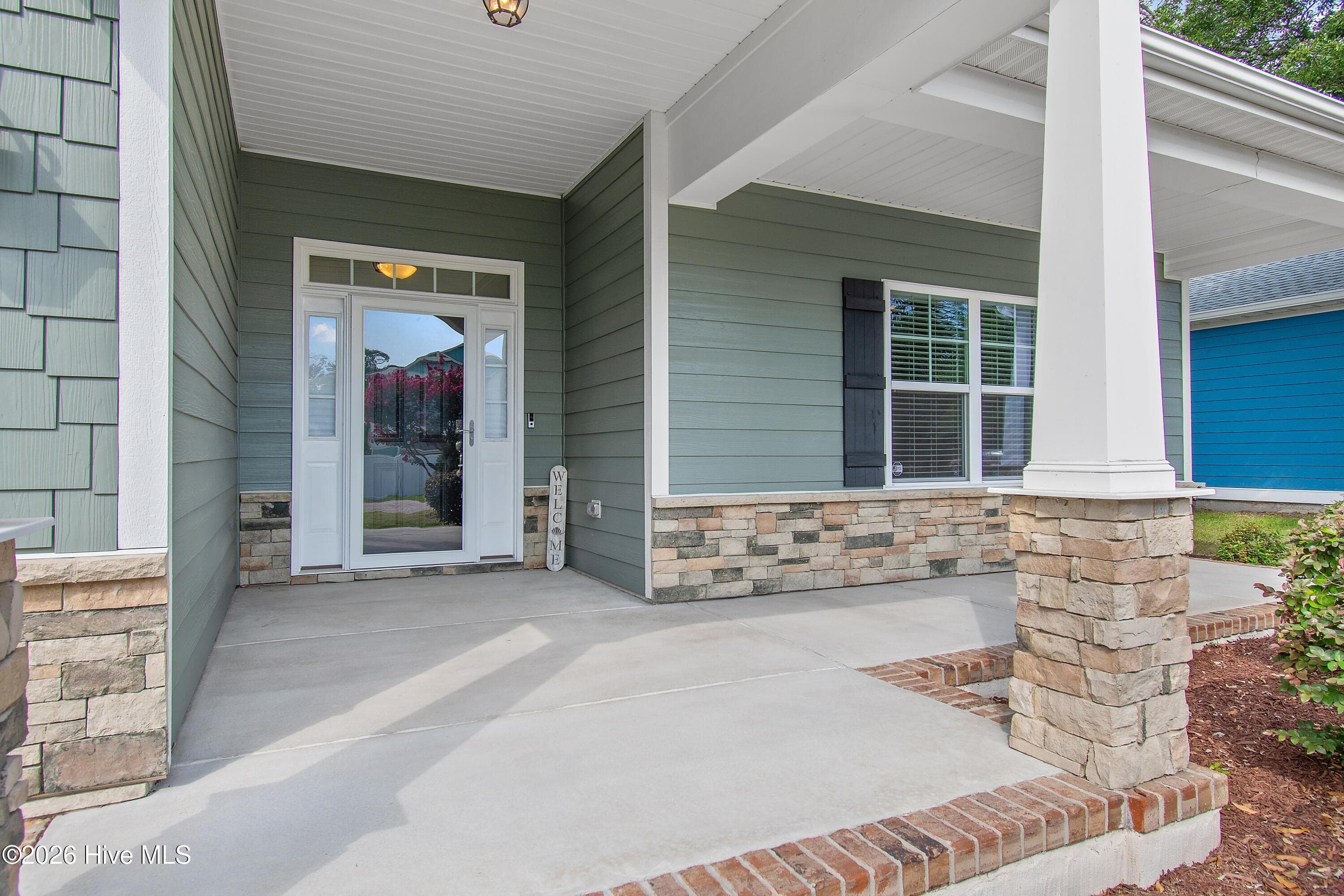Large front porch with stone and brick accents. - 1674 Back Bay Drive SW, Shallotte, NC 28470